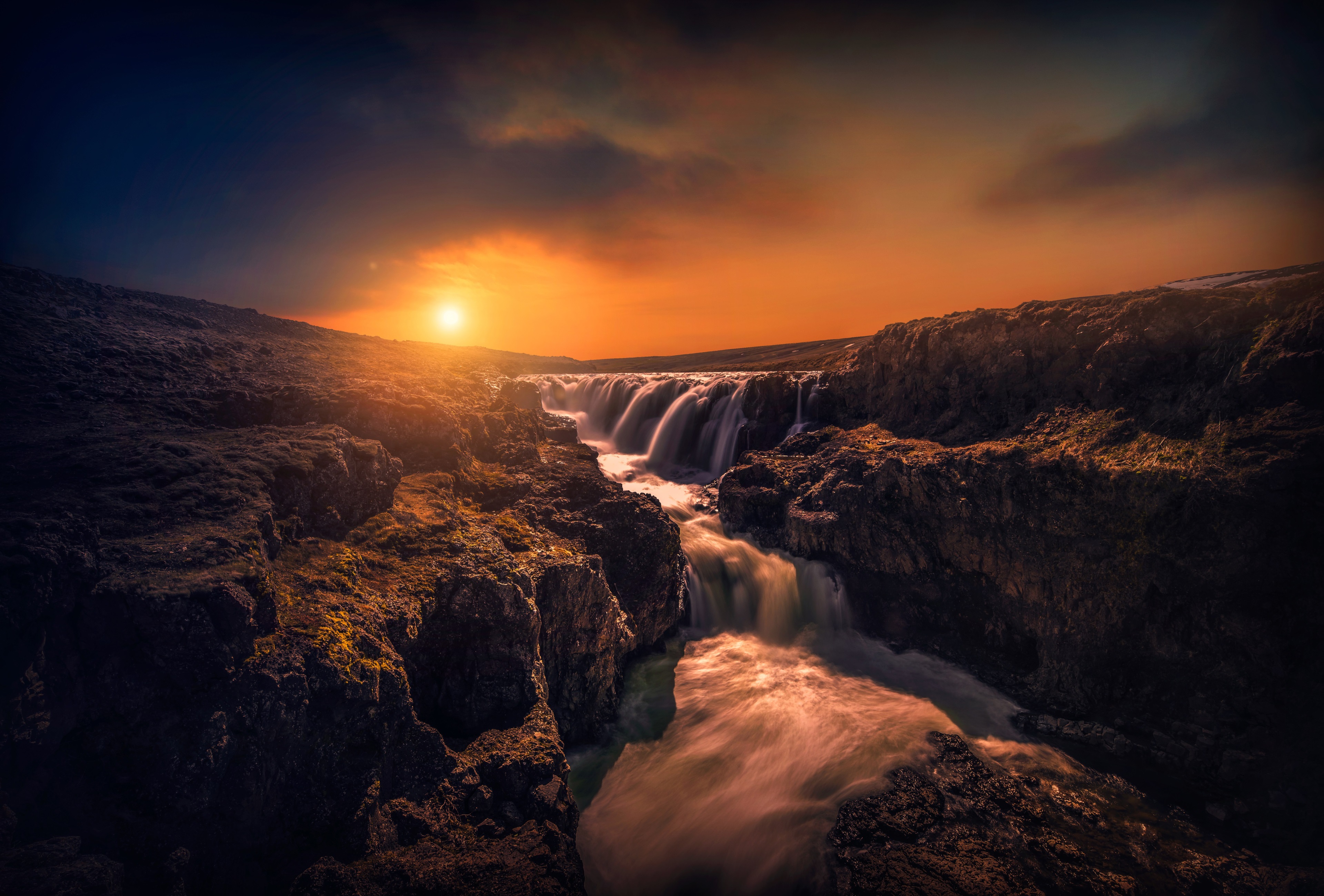 Waterfall in rocky canyon at sunset 4K HD Wallpaper