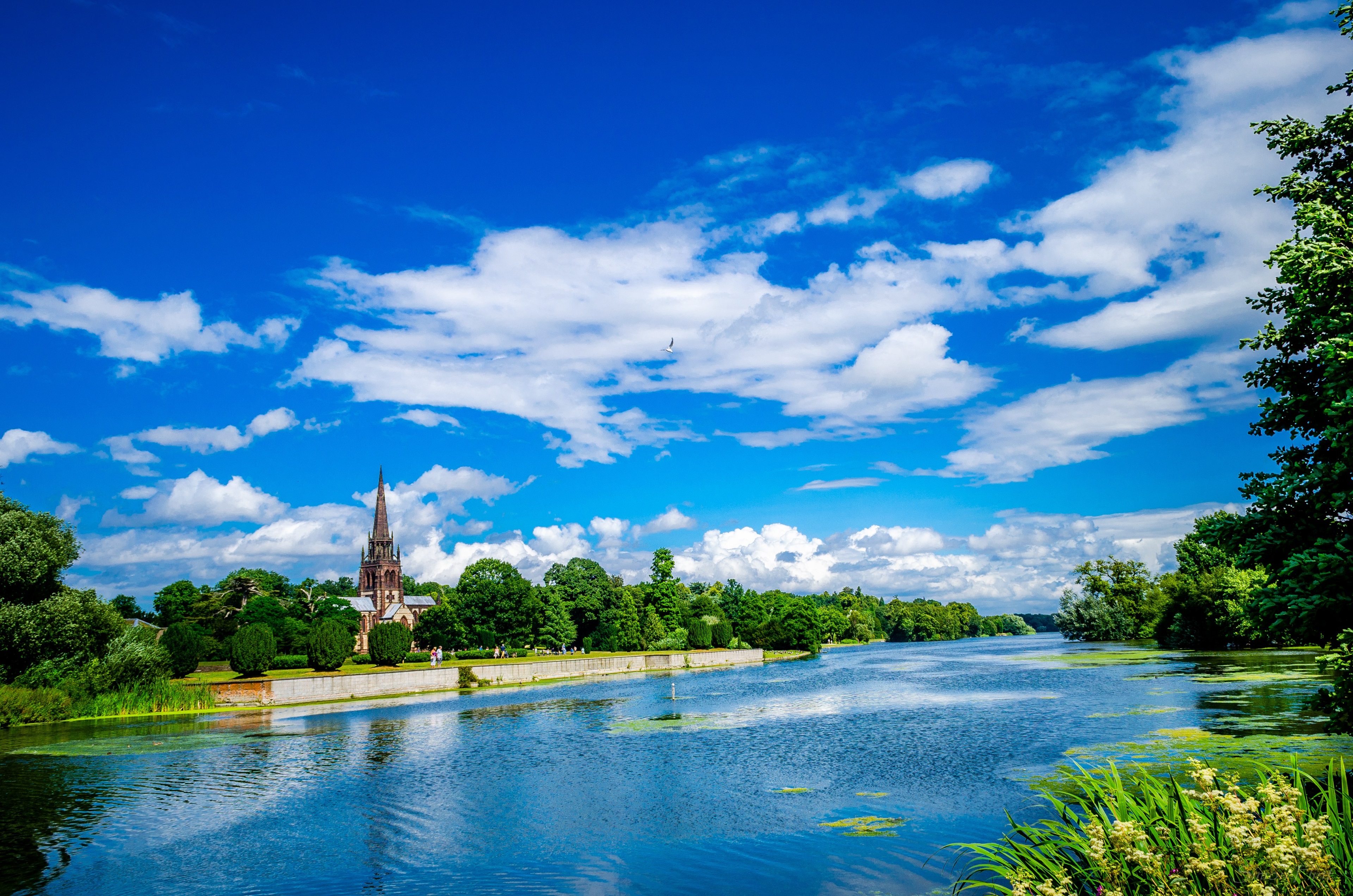 Catholic Church by River Under Blue Sky HD Wallpaper