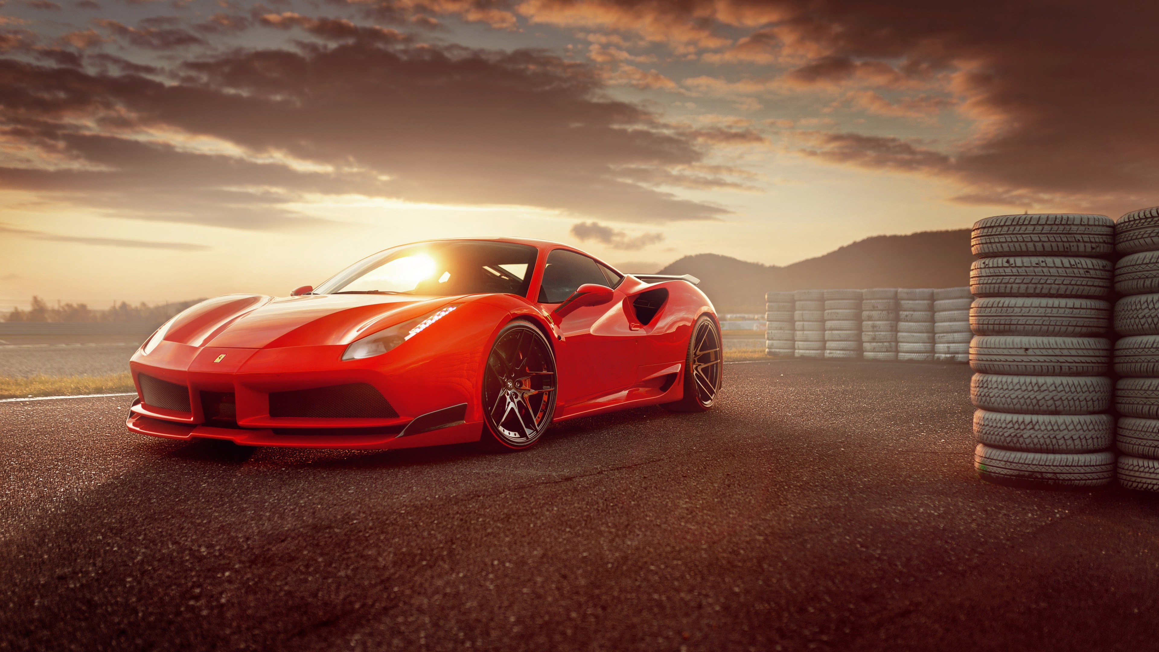Red Ferrari 488 GTB on a race track at sunset HD Wallpaper