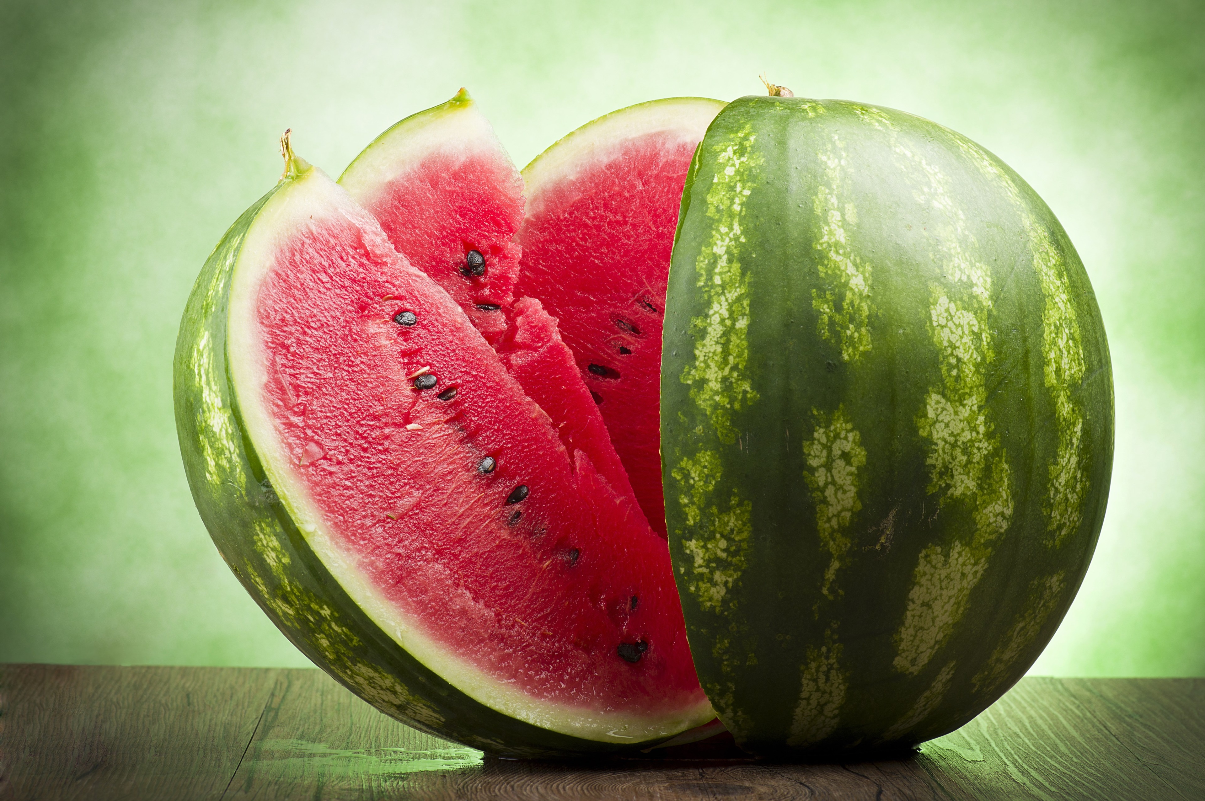 Watermelon slices on a wooden table HD Wallpaper