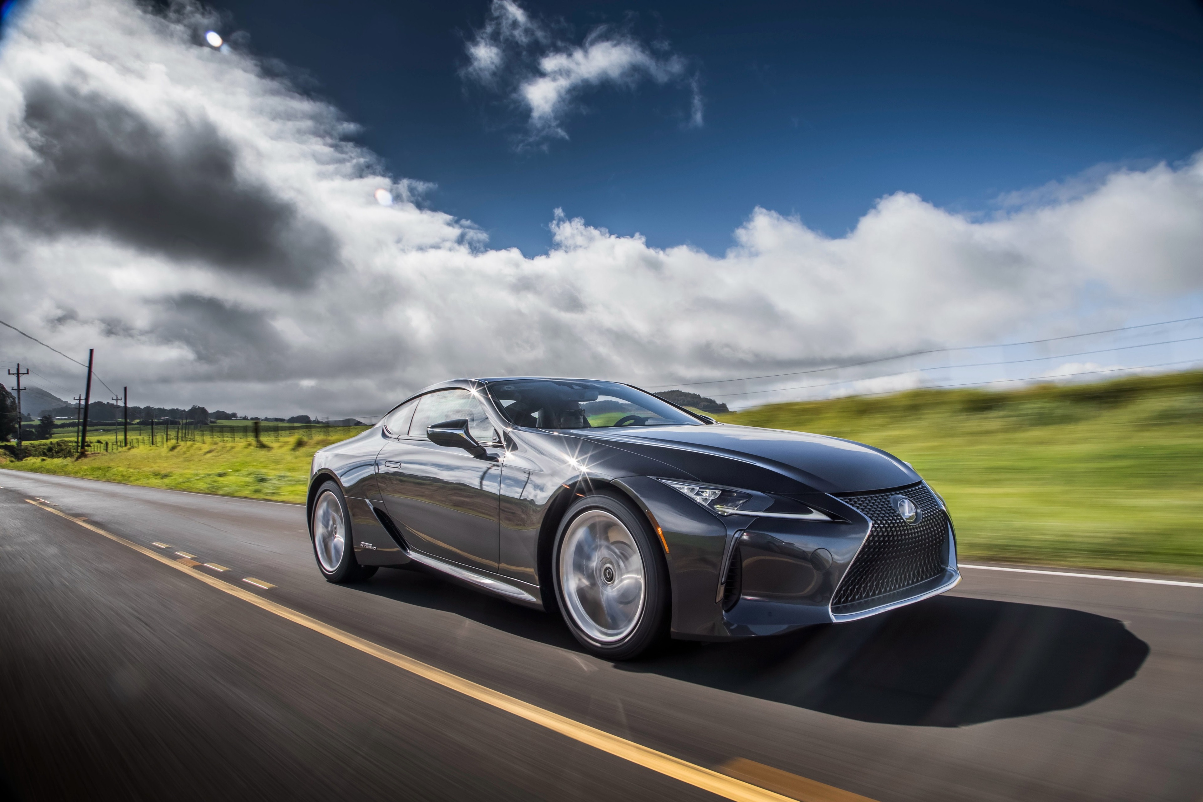 Lexus LC 500 driving on a road HD Wallpaper