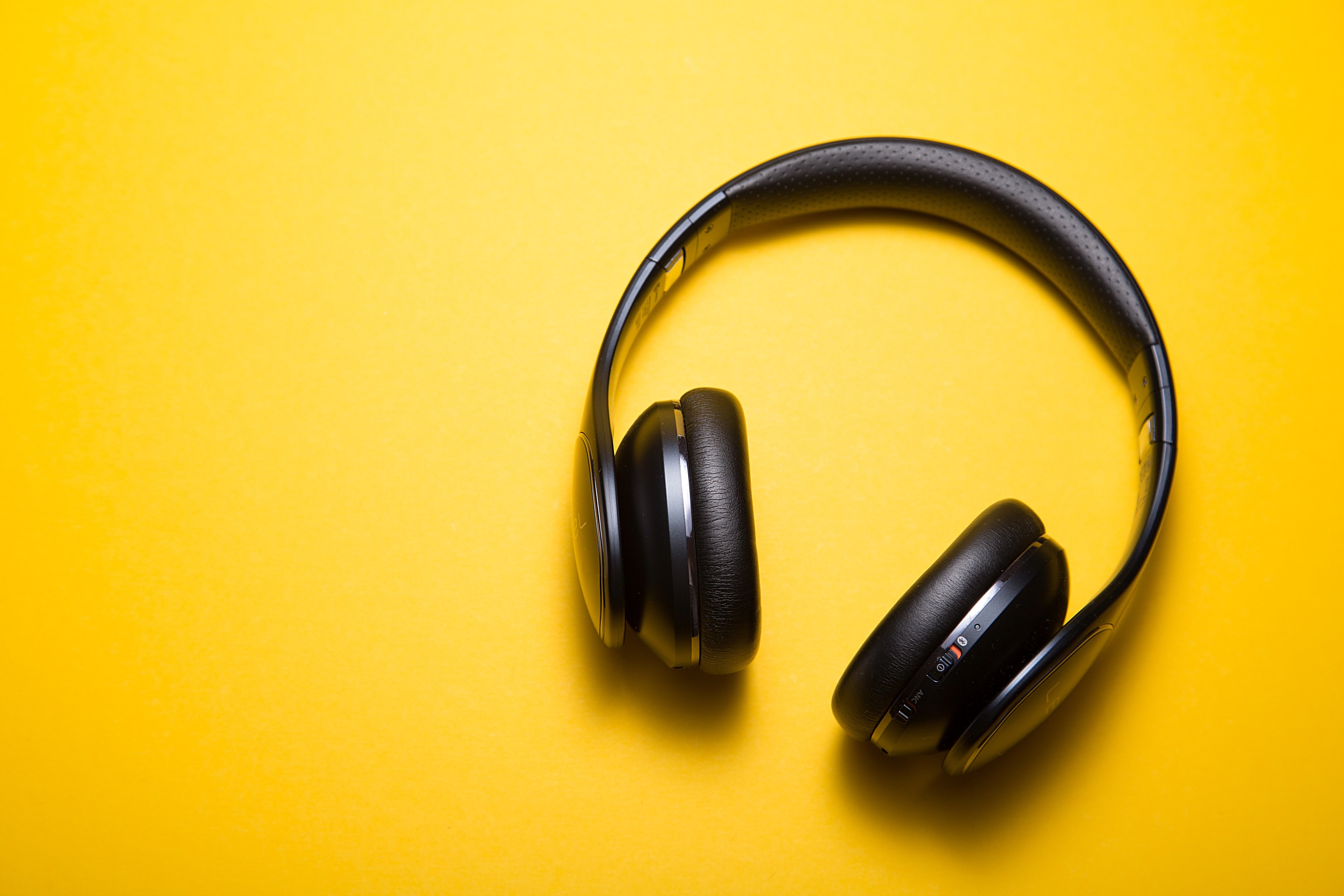 Black headphones on a yellow background HD Wallpaper
