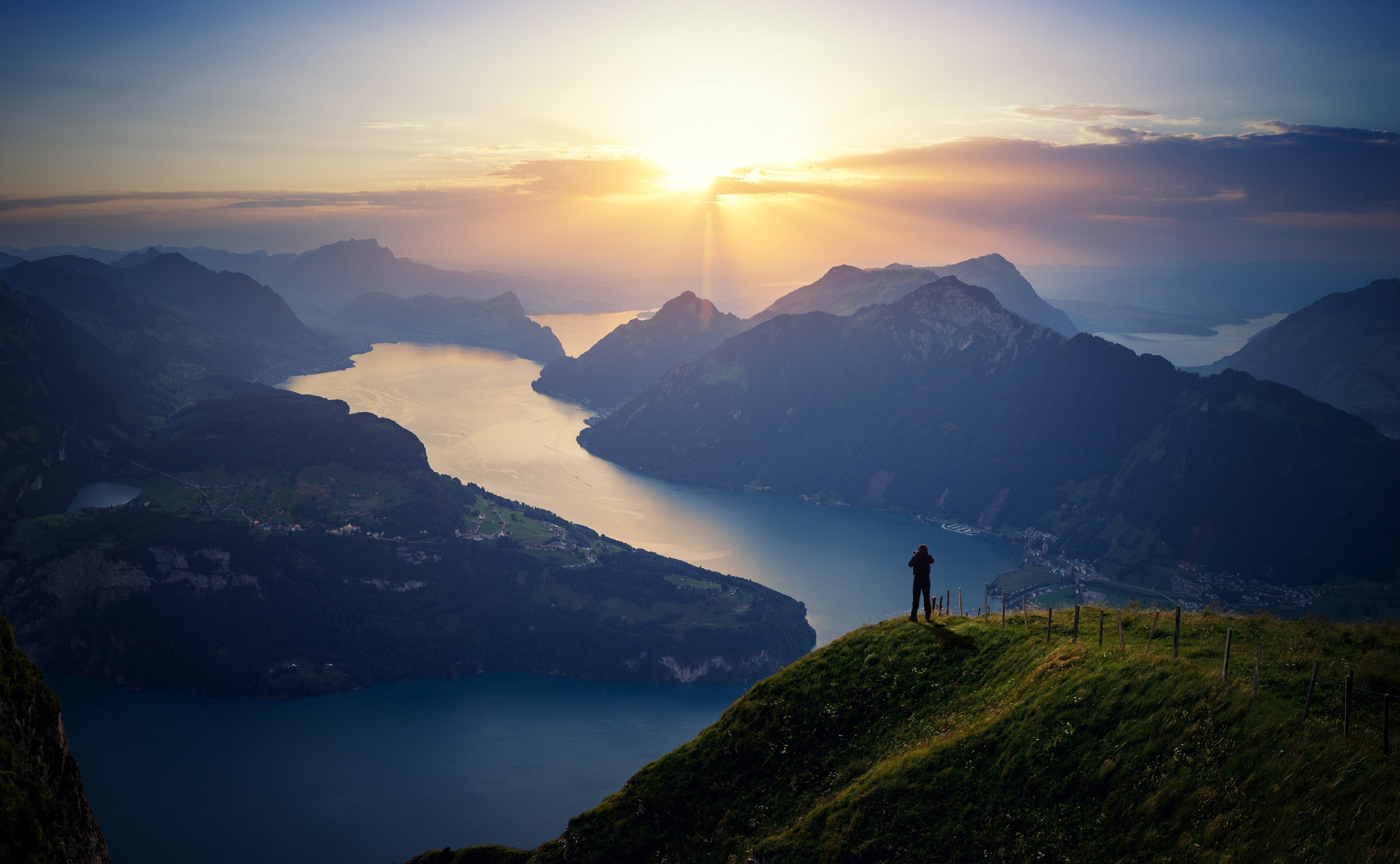 Man on mountain overlooking Lake Lucerne at sunset 4K HD Wallpaper