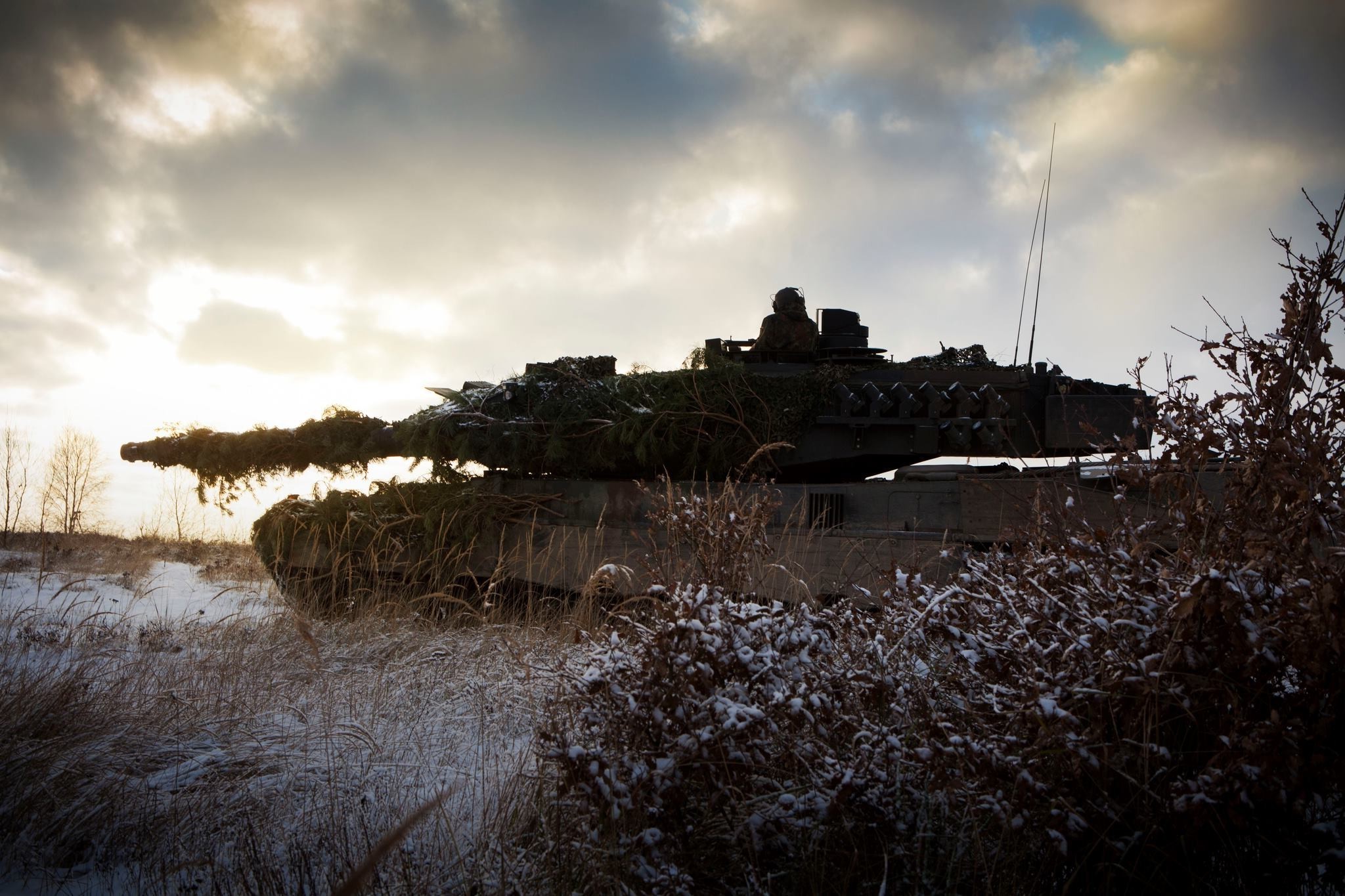 Leopard 2 tank in a snowy field HD Wallpaper
