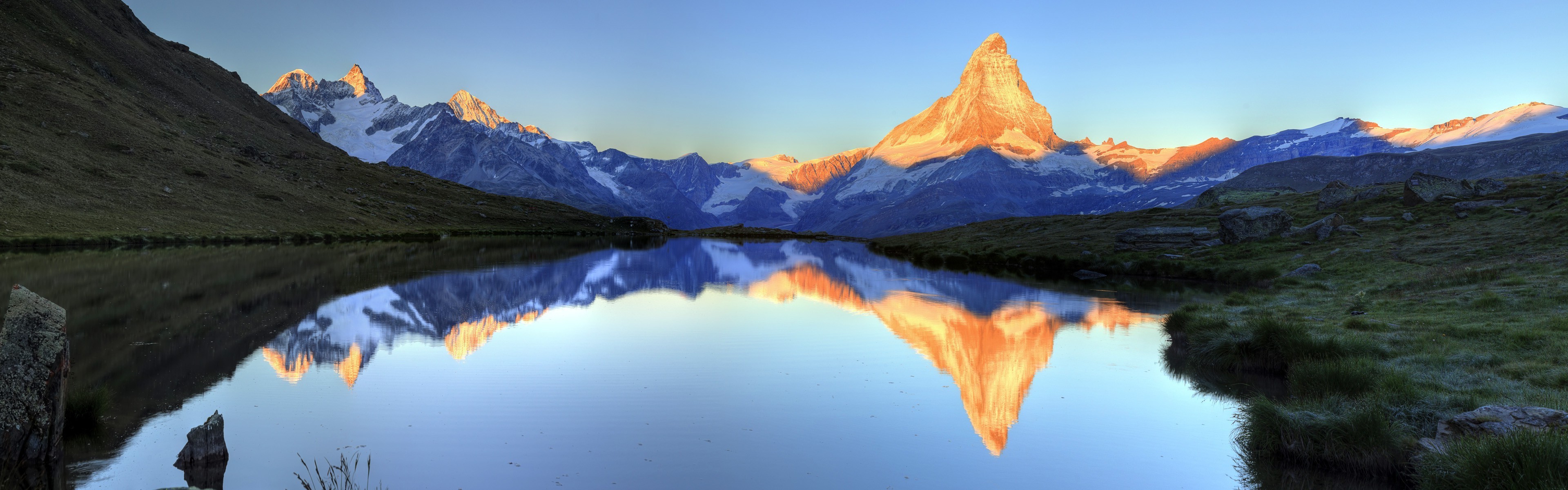 Matterhorn mountain reflected in a lake at sunrise HD Wallpaper