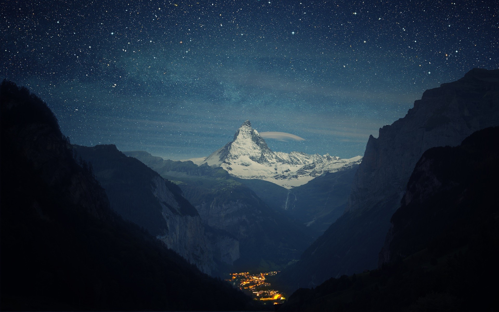 Matterhorn mountain at night with stars and village lights HD Wallpaper