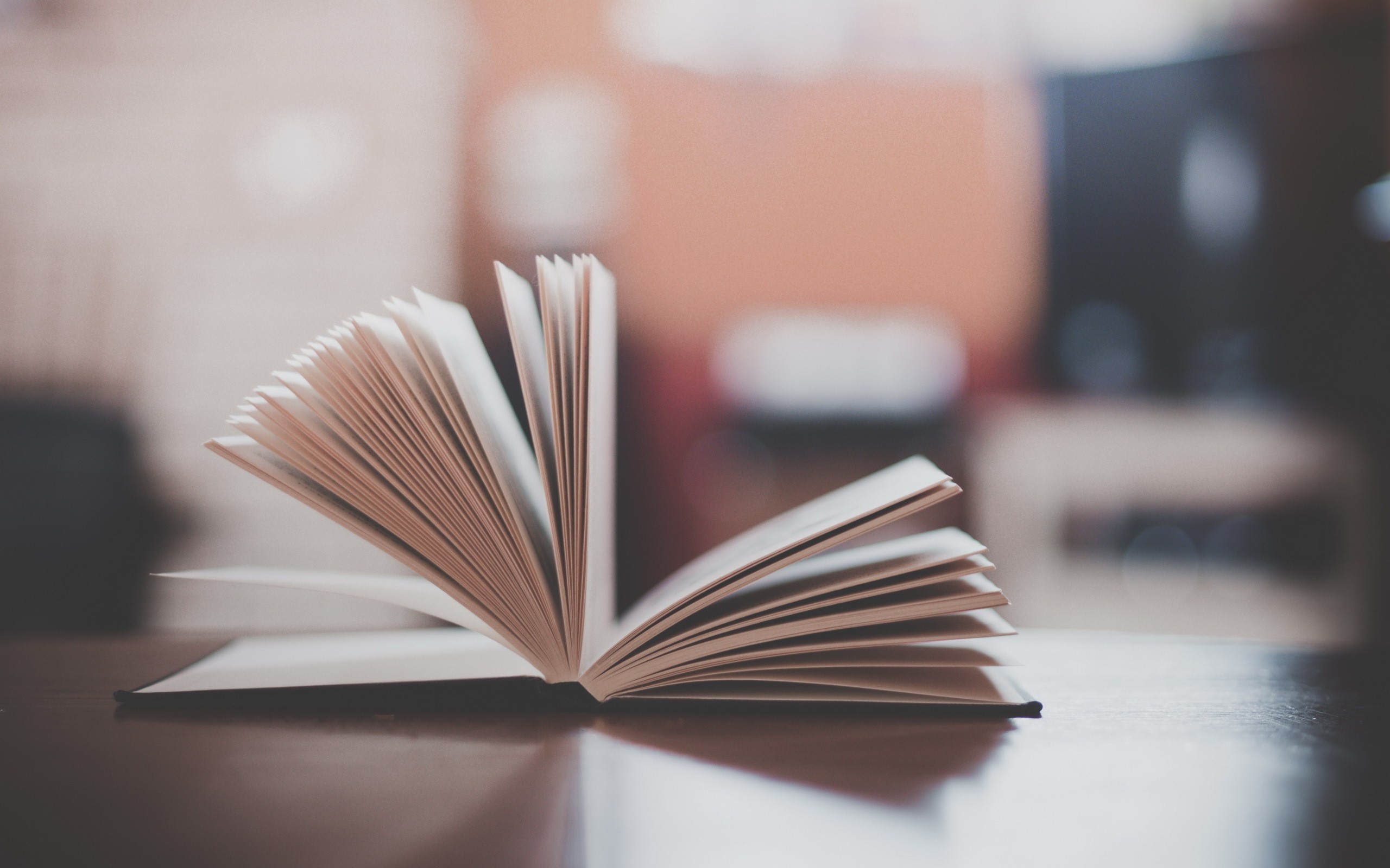 Open book on a wooden table HD Wallpaper