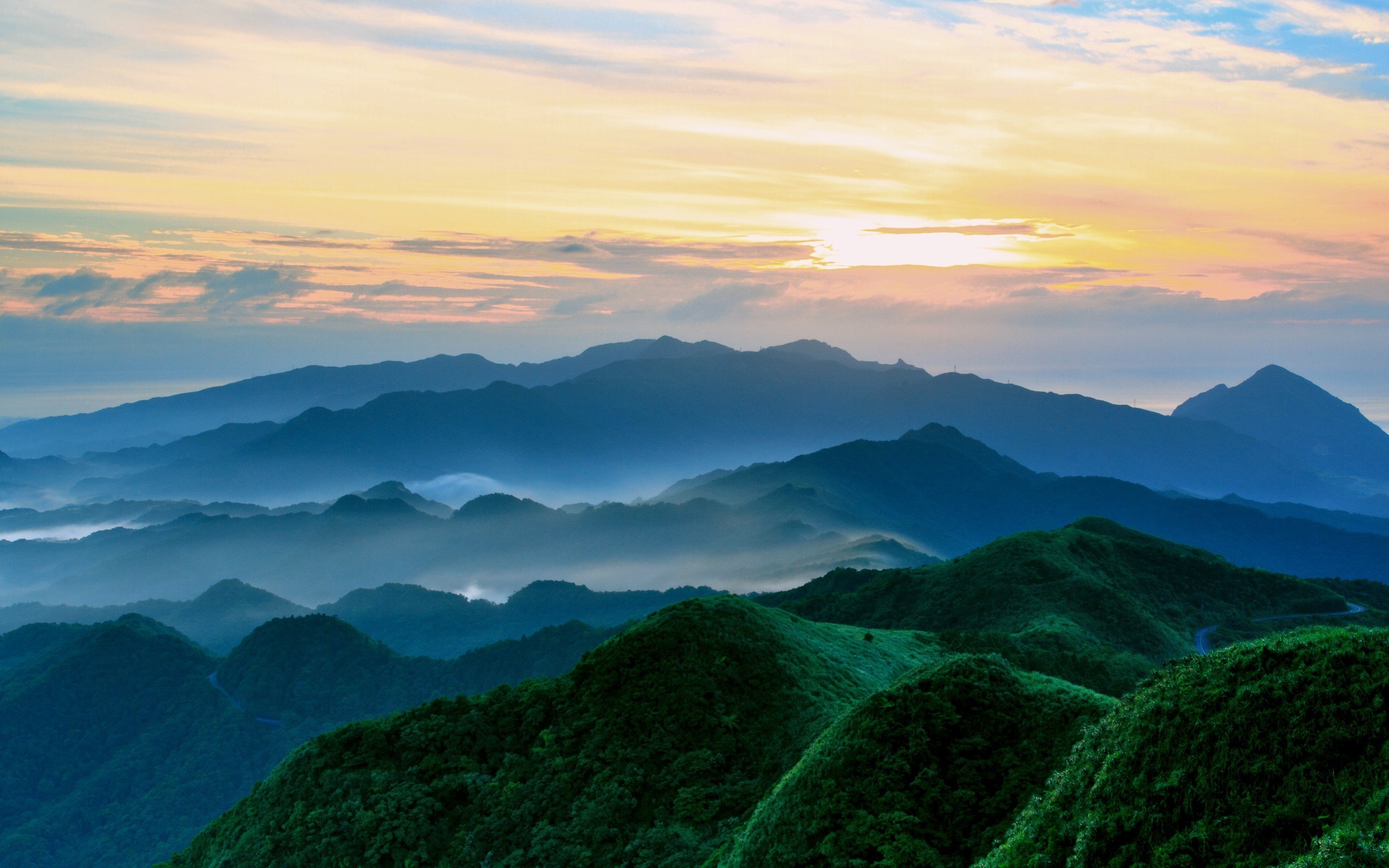 Mountain range with mist at sunset HD Wallpaper