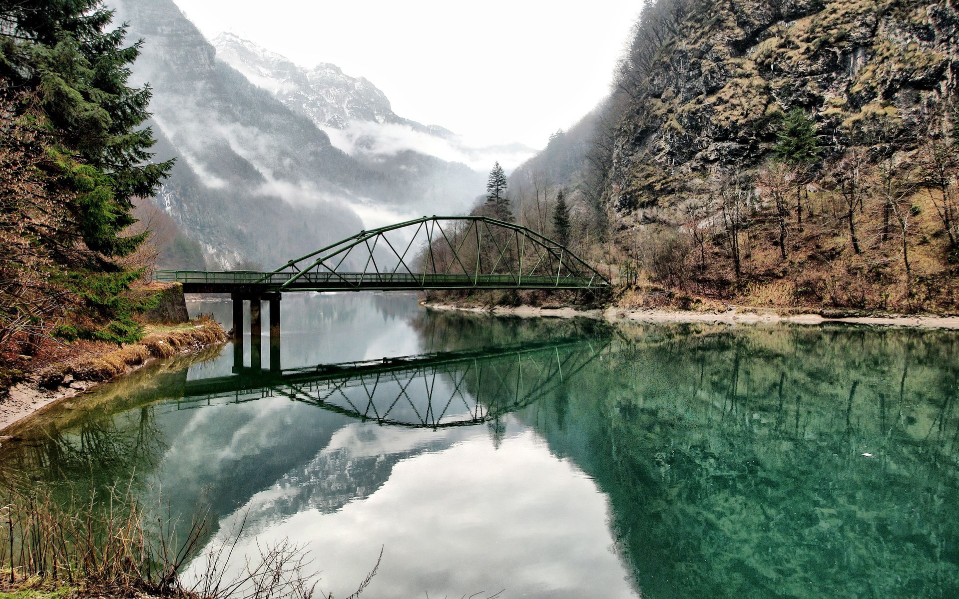 Green bridge over a lake with mountains HD Wallpaper