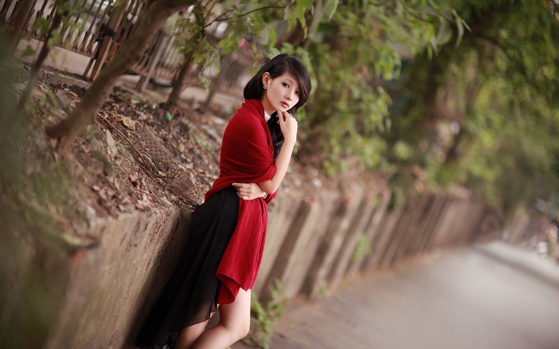 Asian woman in red shawl and black dress outdoors HD Wallpaper