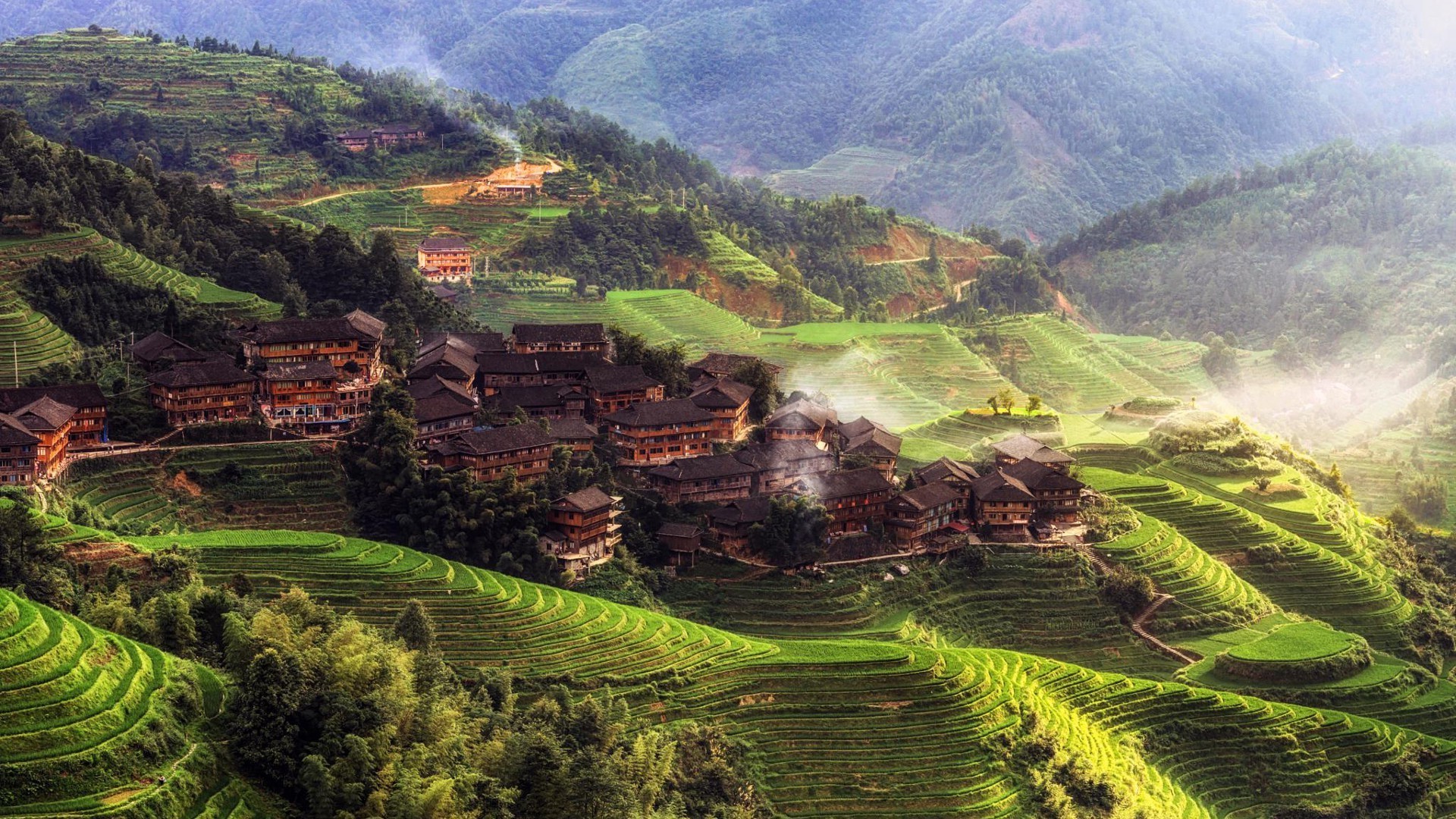 Terraced Rice Fields and Village in Misty Morning Hills HD Wallpaper