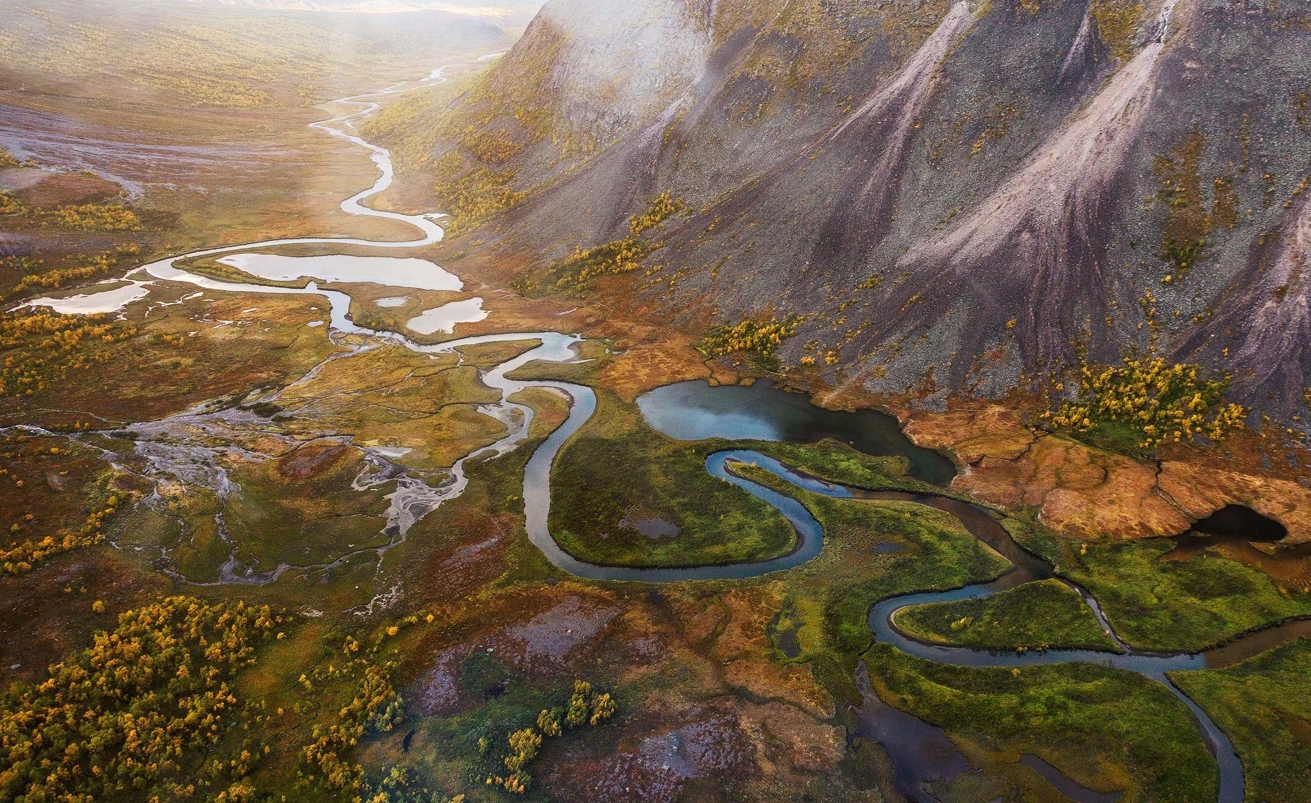 Aerial view of a winding river valley in fall HD Wallpaper