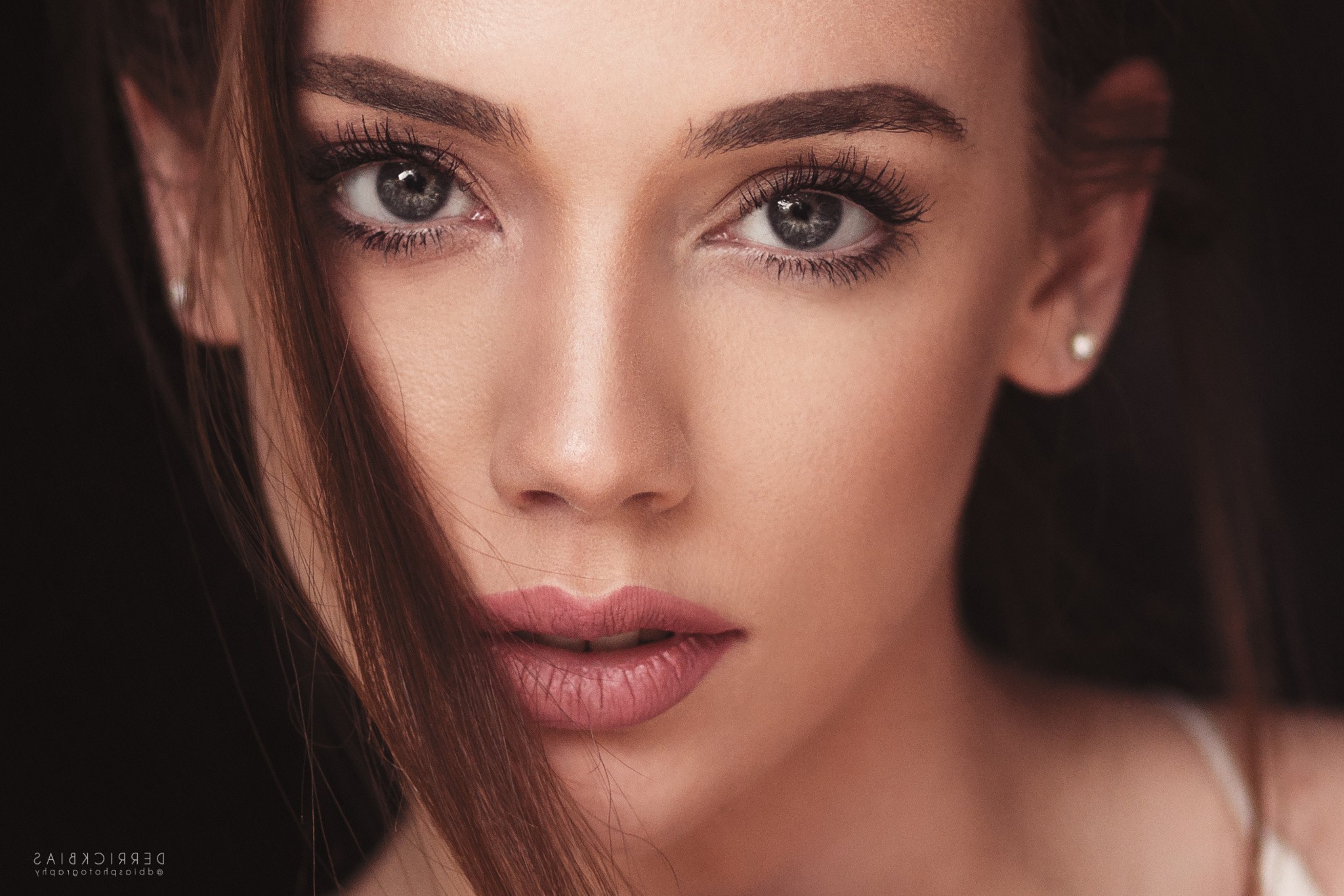 Woman's face with hair covering part of her face HD Wallpaper
