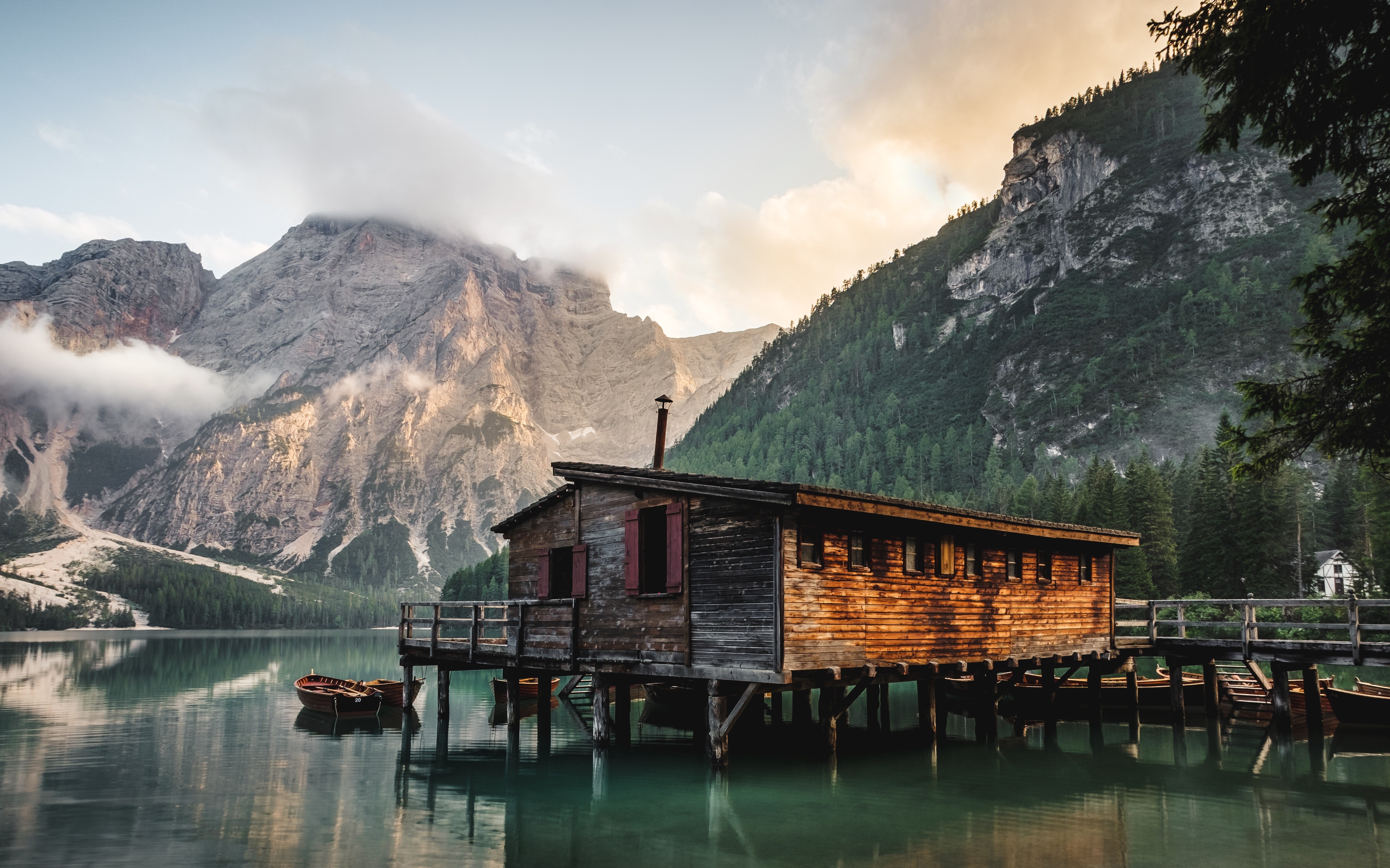 Wooden boathouse on a lake with mountains and clouds HD Wallpaper