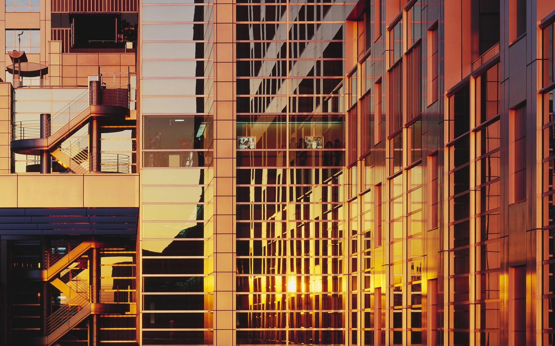 Modern architecture with glass facade reflecting sunset HD Wallpaper