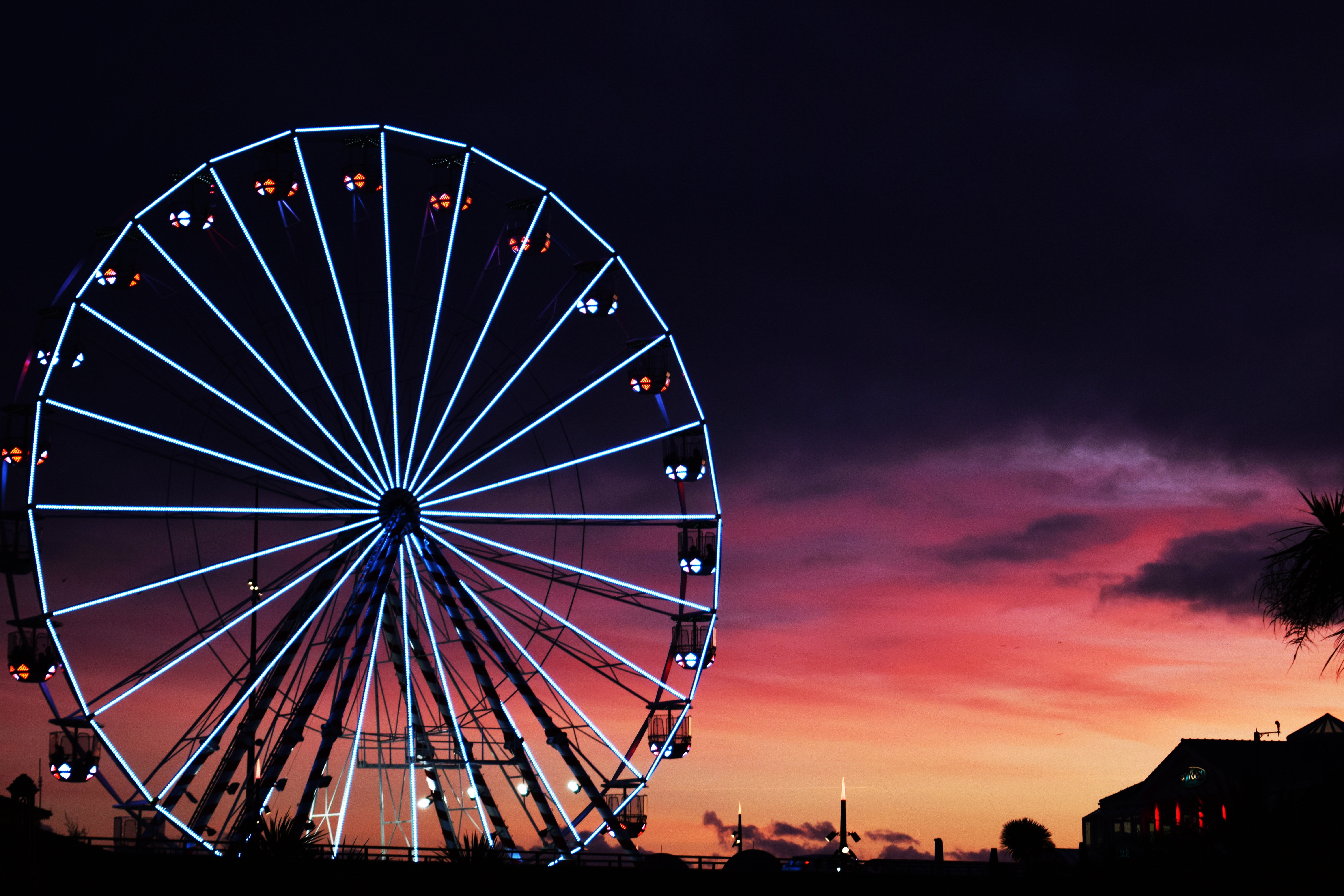 Ferris wheel at sunset with colorful clouds HD Wallpaper