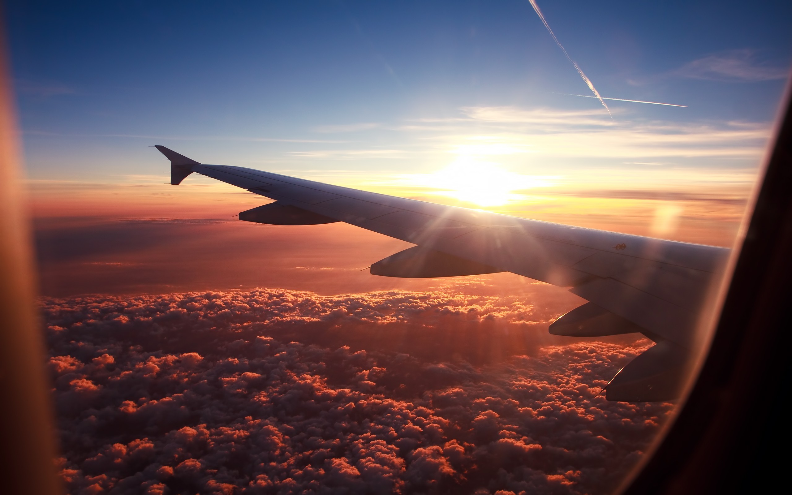 Airplane wing over clouds at sunset HD Wallpaper