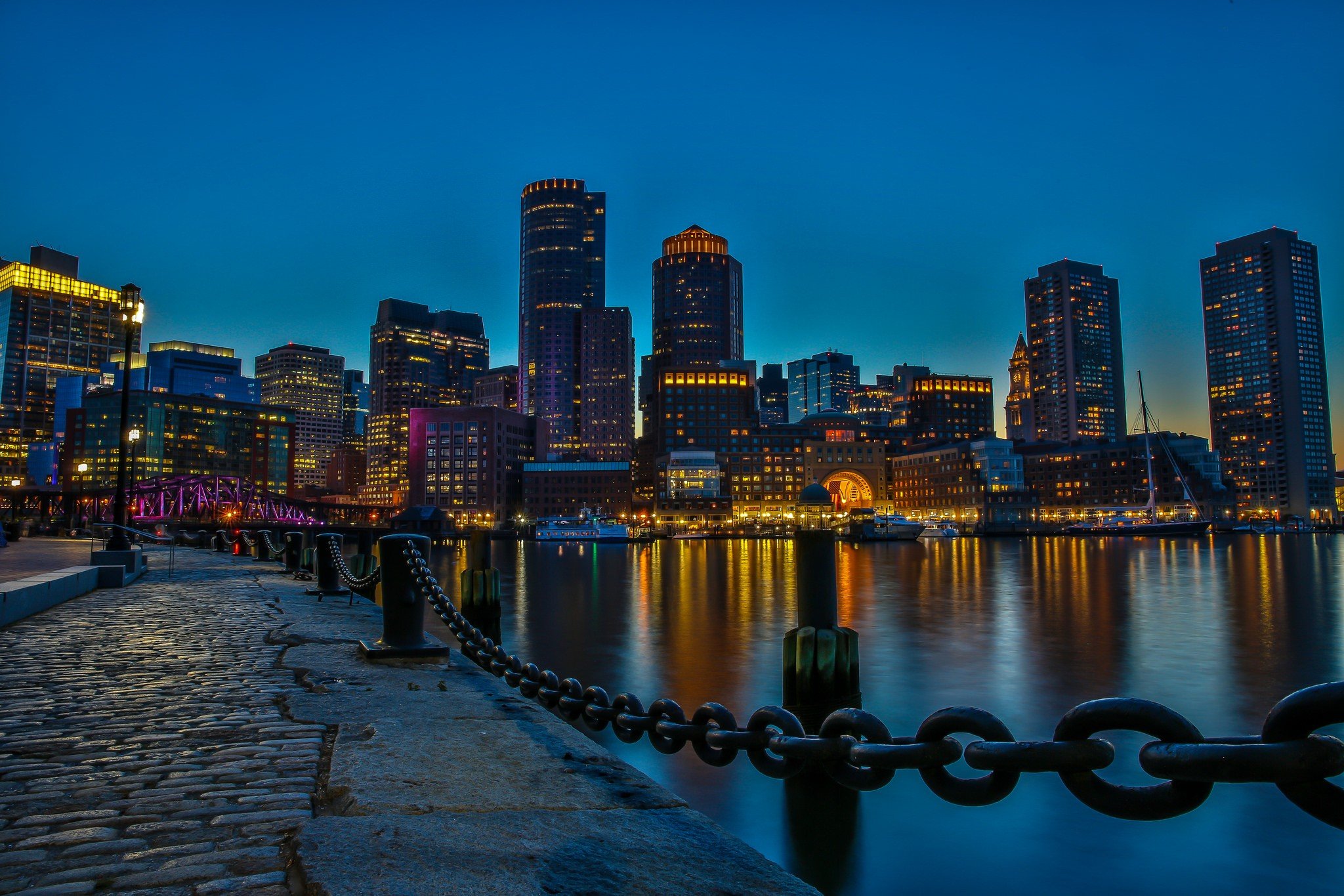 Boston cityscape at night with waterfront and cobblestone dock HD Wallpaper