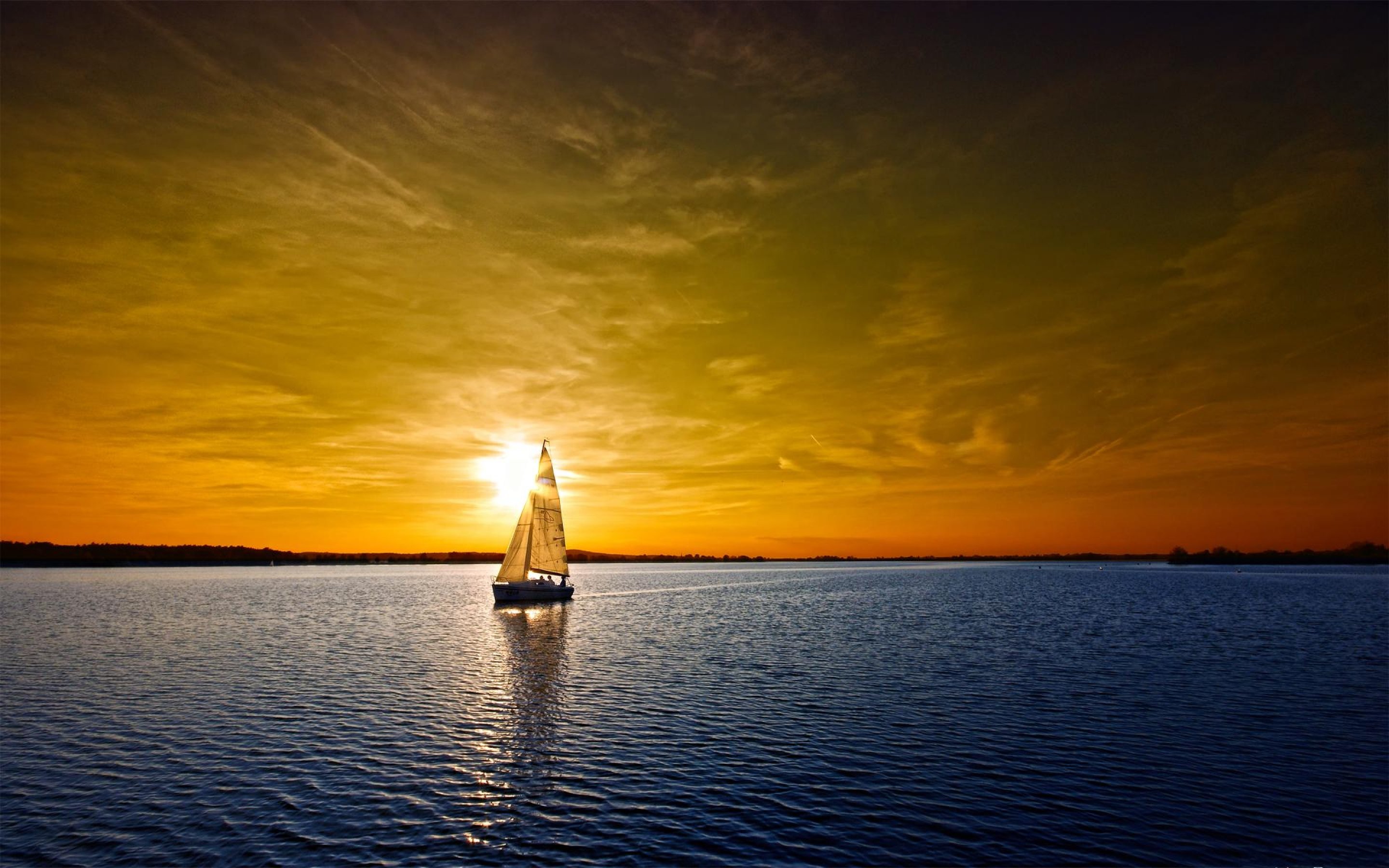 Sailboat on a lake at sunset HD Wallpaper