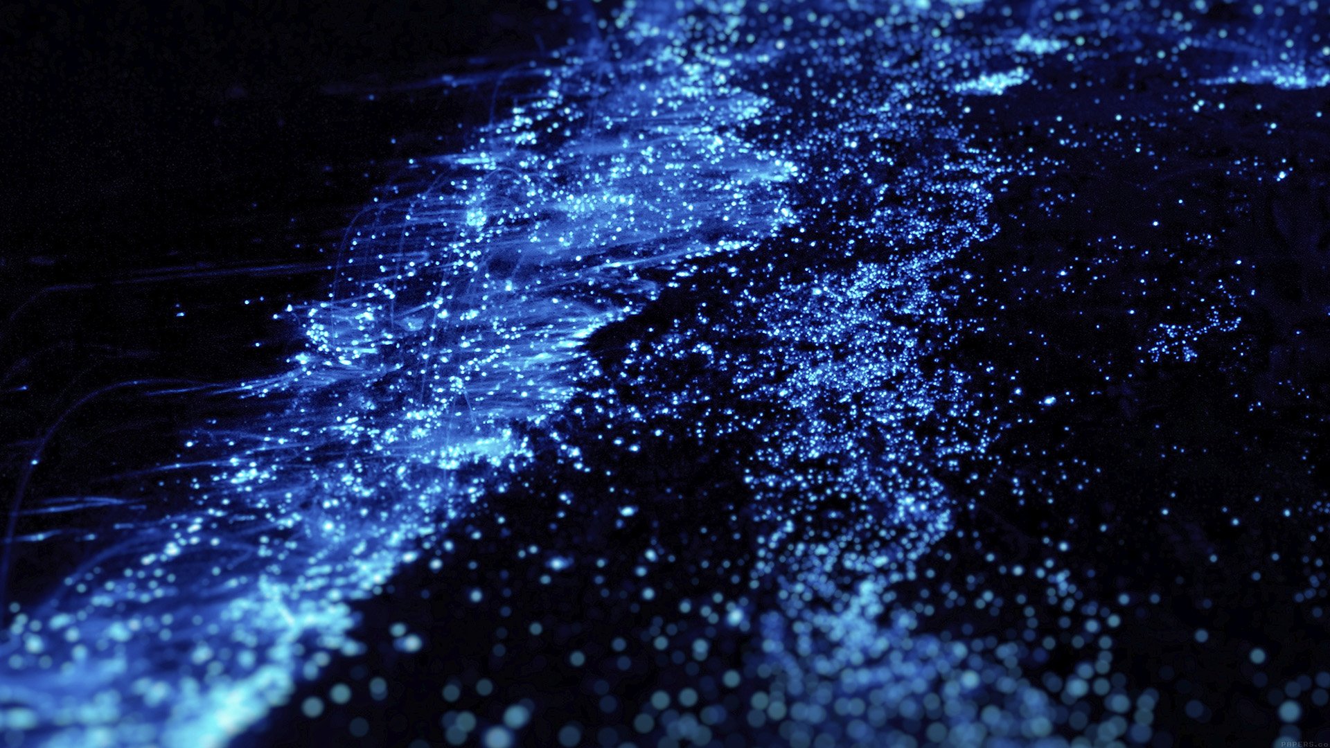 Abstract bioluminescent plankton in dark water HD Wallpaper