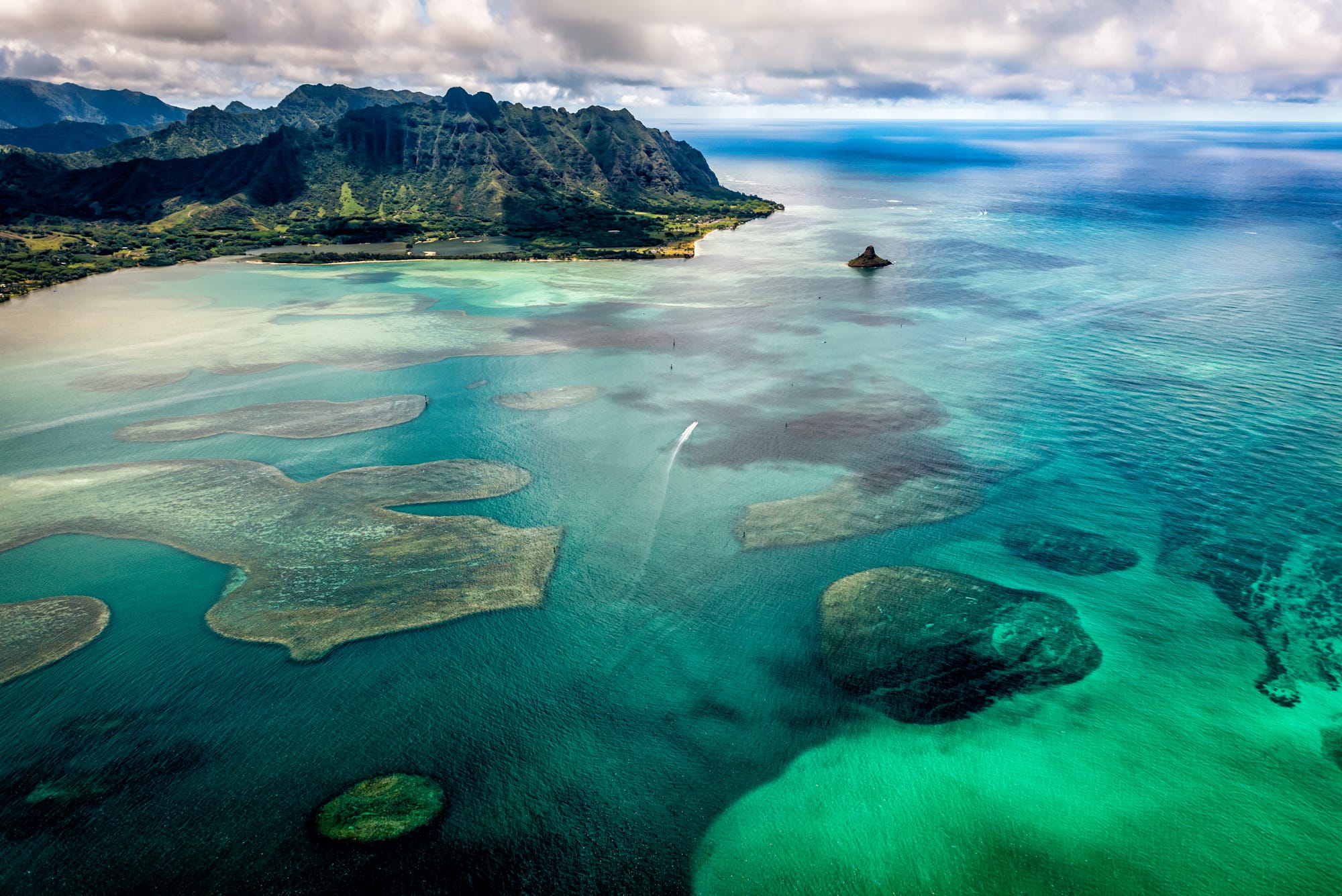 Aerial view of Oahu coastline with mountains and turquoise water HD Wallpaper