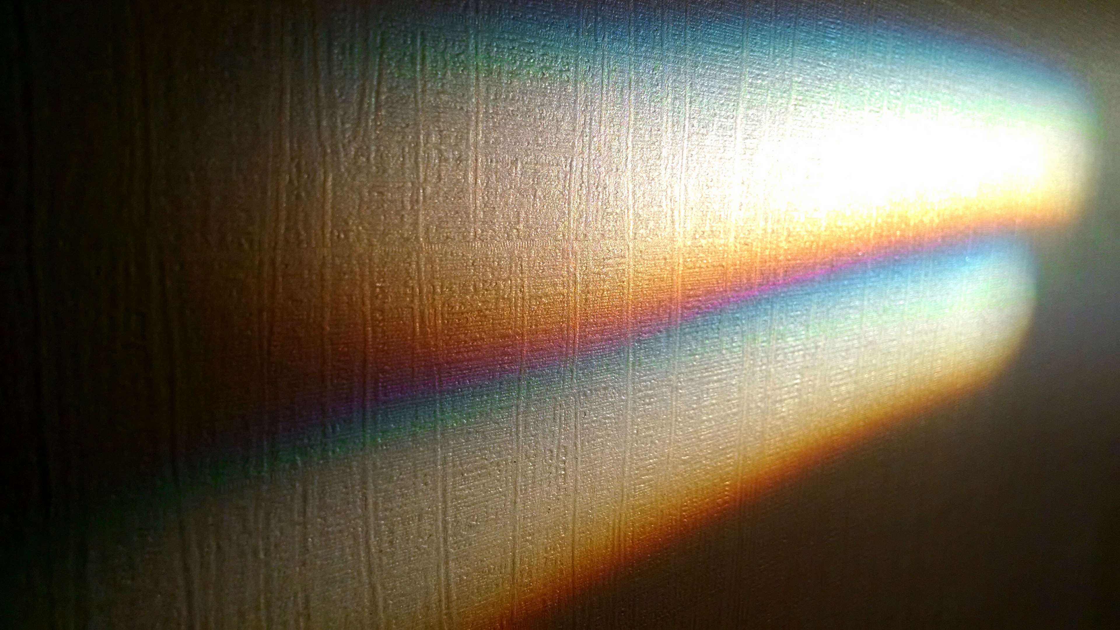 Rainbow light spectrum on textured surface HD Wallpaper