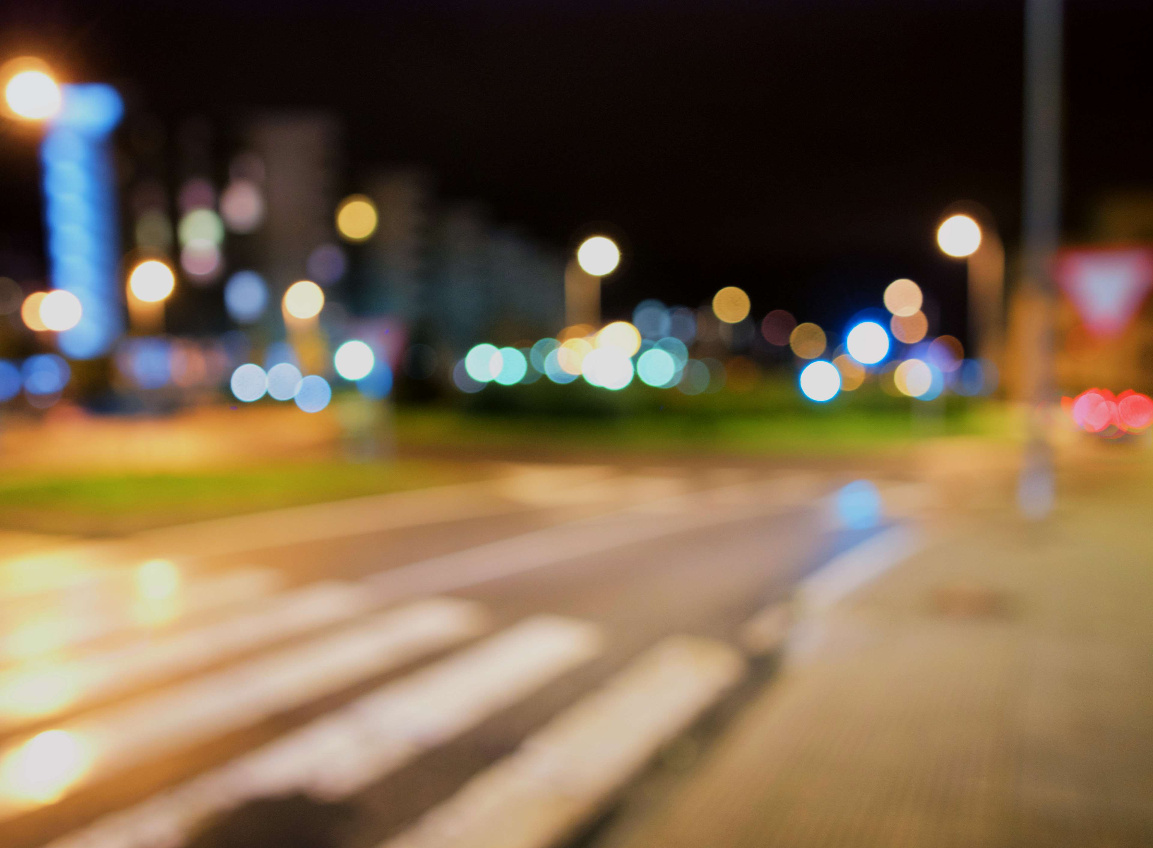 Bokeh city lights at night on a street HD Wallpaper