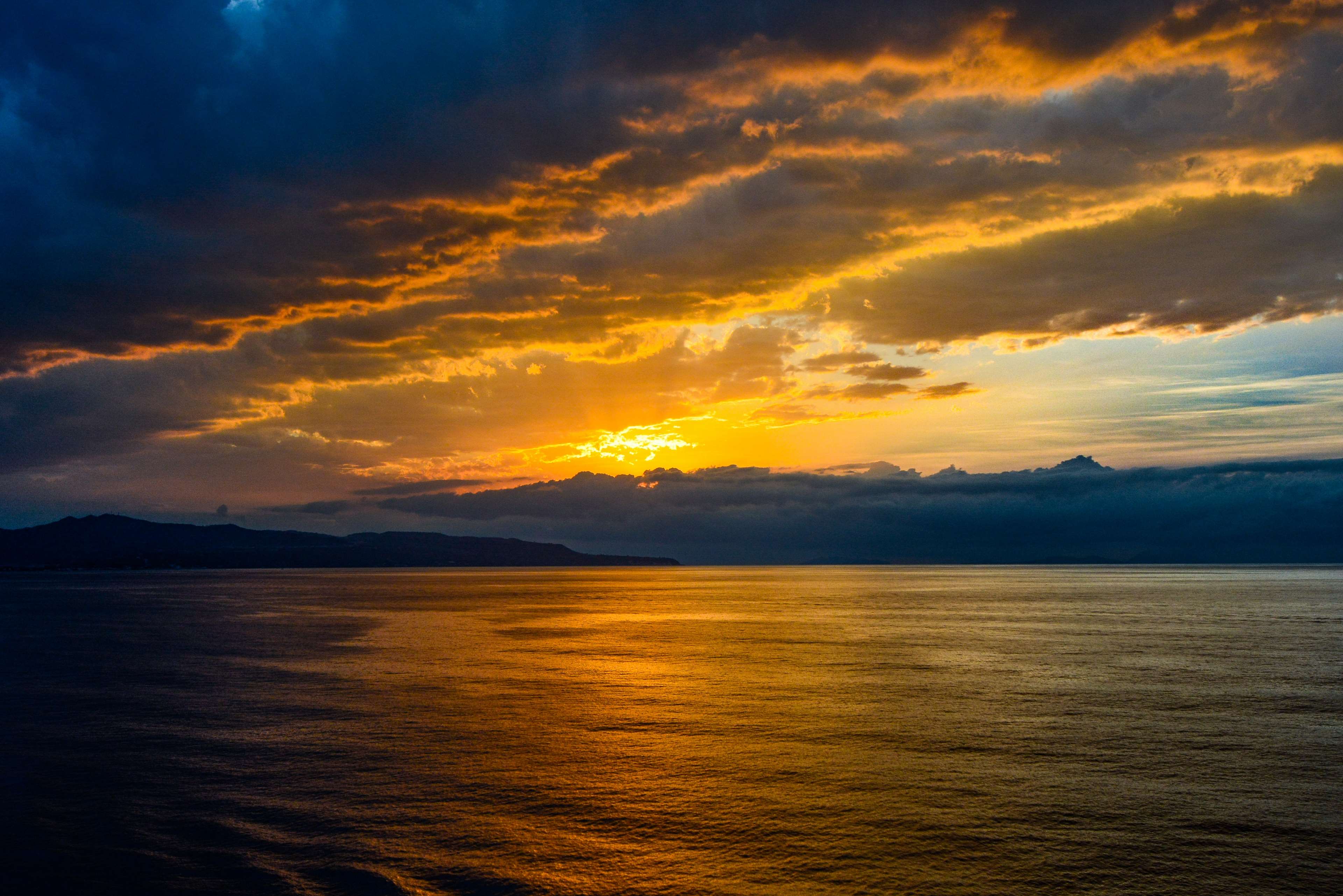 Sunset over the Mediterranean Sea with Island and Stormy Clouds HD Wallpaper