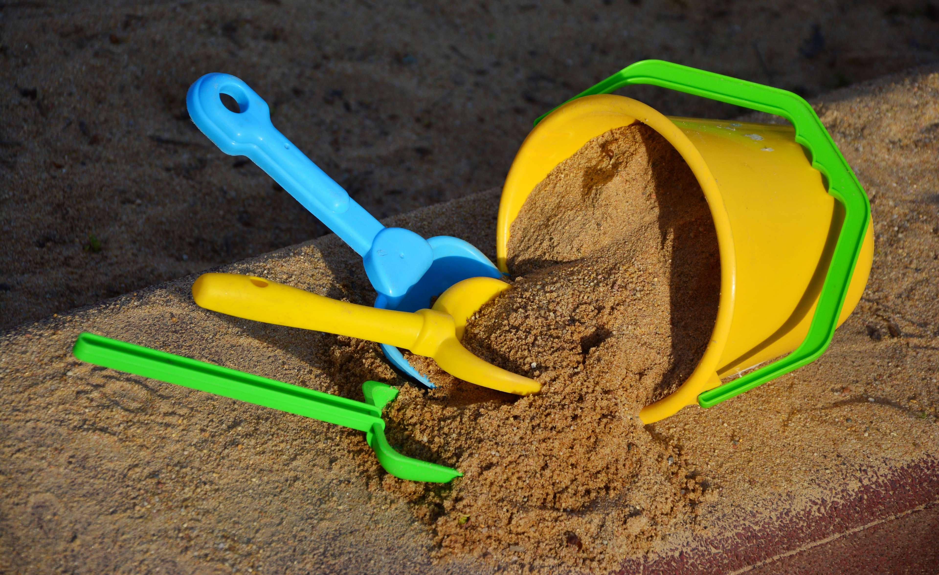 Sand bucket and toys in a sand pit 4K HD Wallpaper