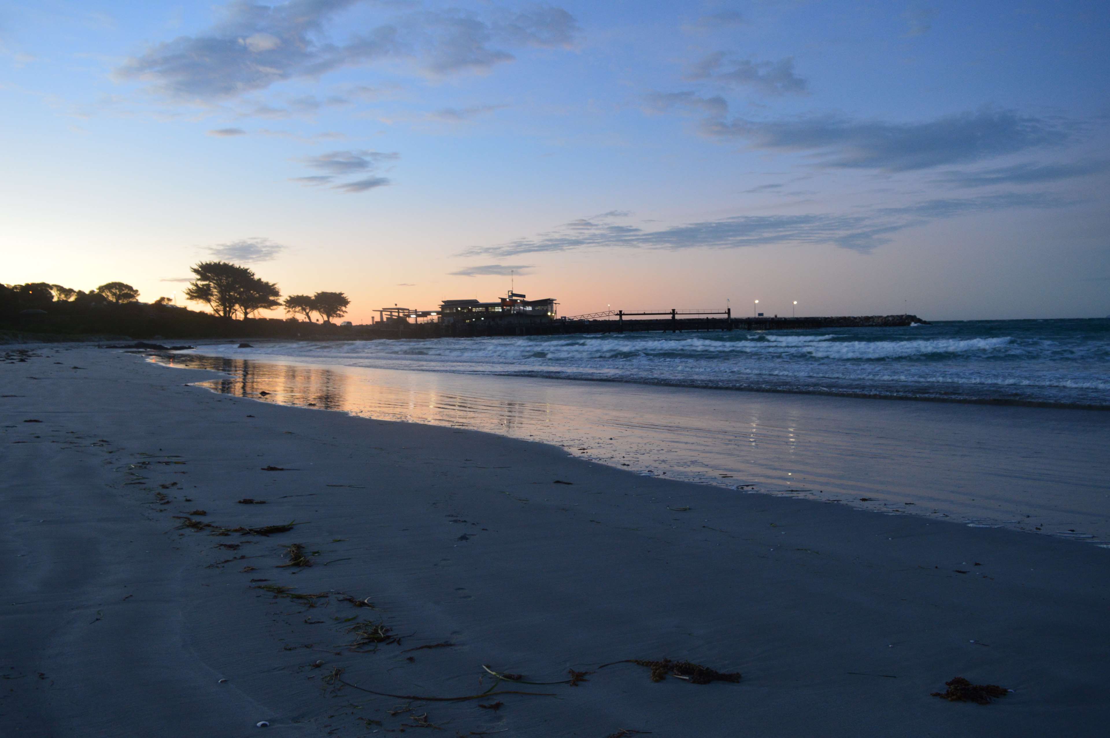 Beach at sunset with pier HD Wallpaper