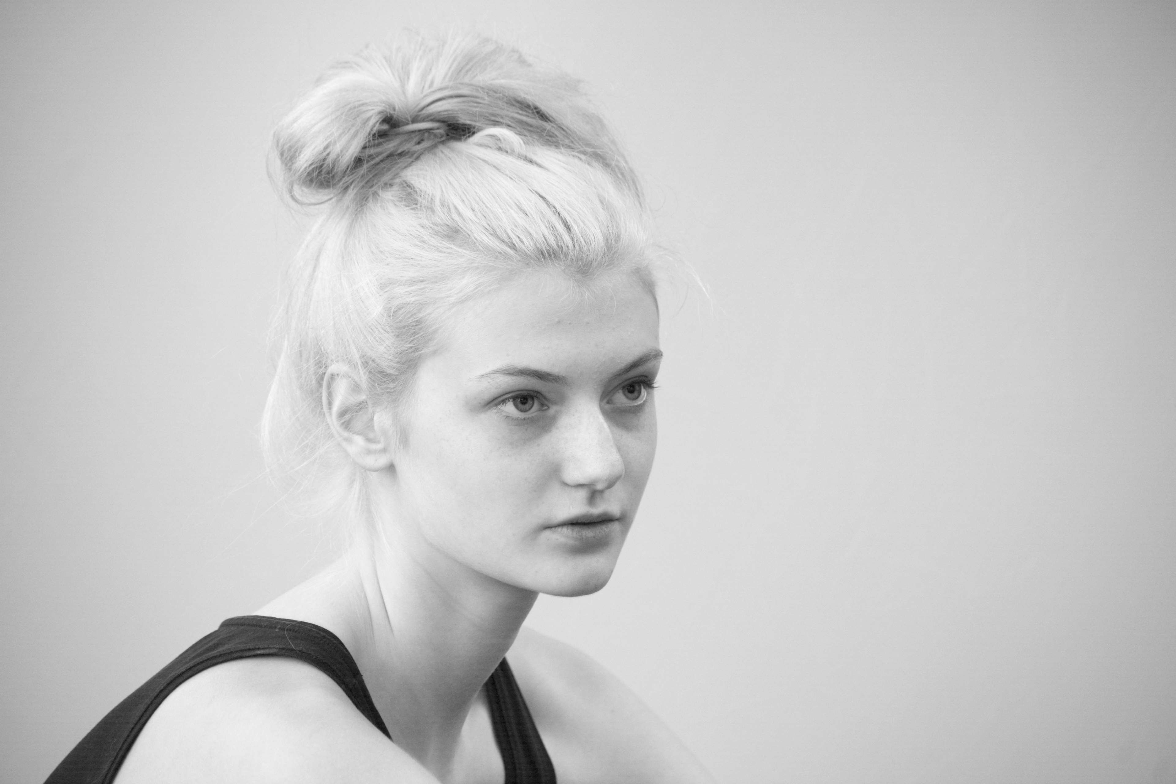 Young blonde woman in black tank top, black and white portrait HD Wallpaper