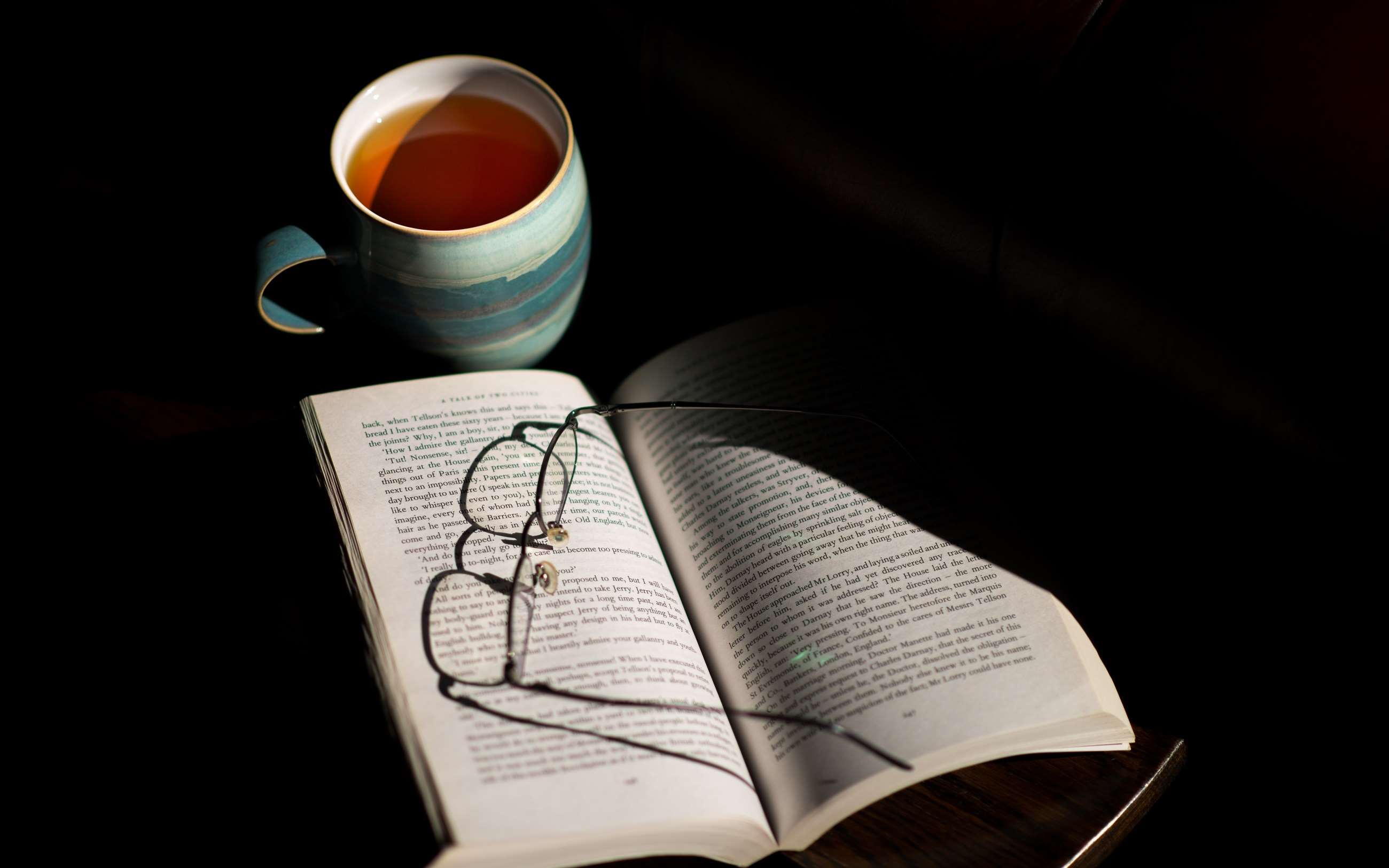 Open book with eyeglasses and cup of tea HD Wallpaper