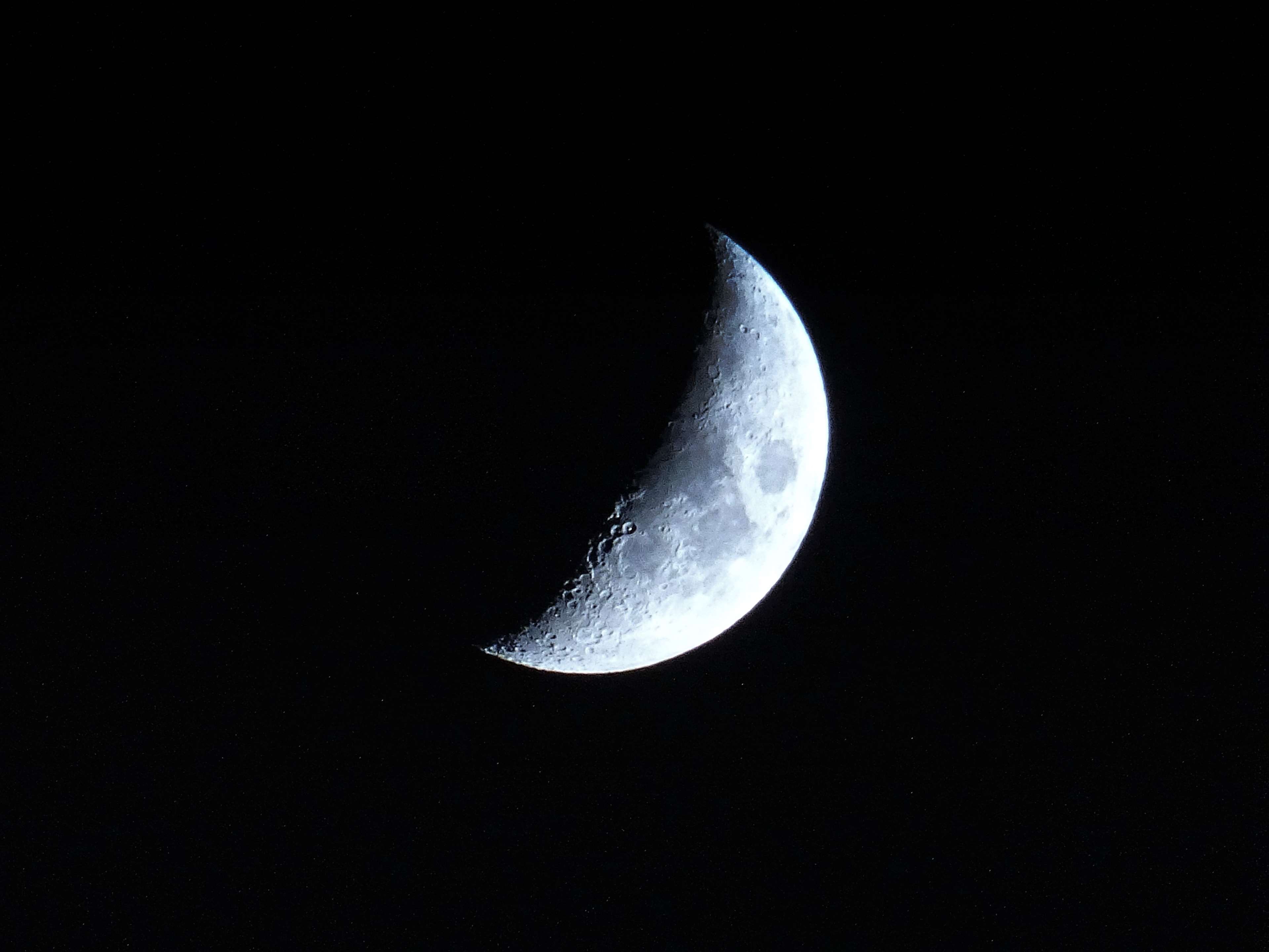 Crescent moon with craters in dark space HD Wallpaper
