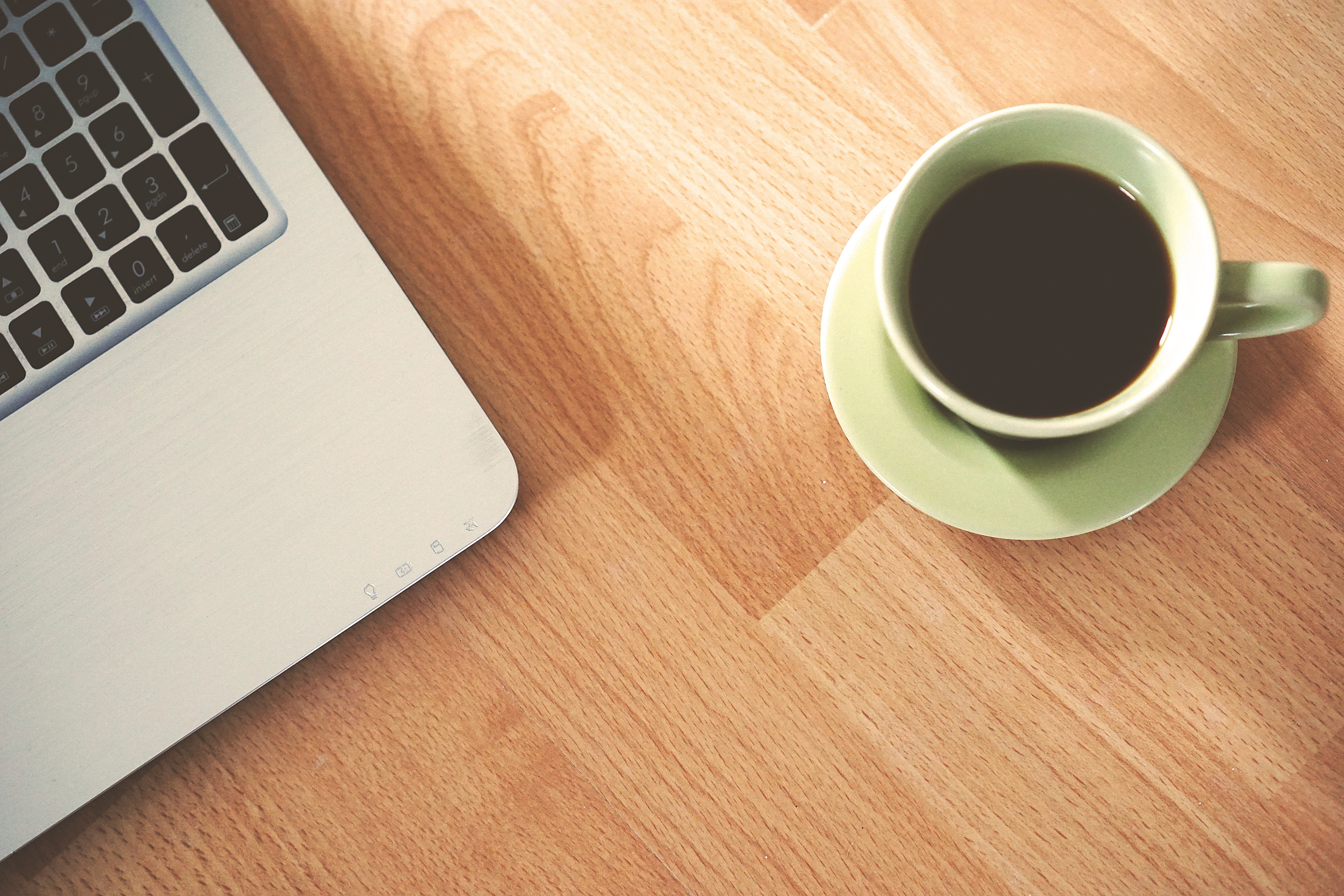 Macbook and a cup of coffee on a wooden desk HD Wallpaper