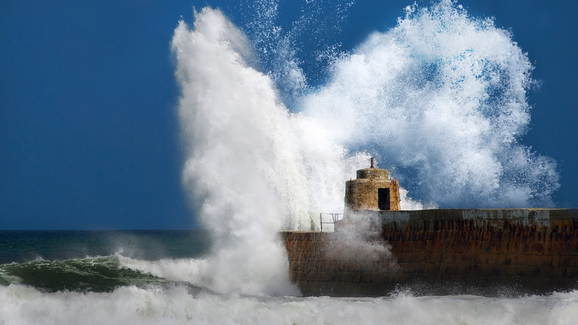Powerful Ocean Wave Crashing on Stone Pier HD Wallpaper