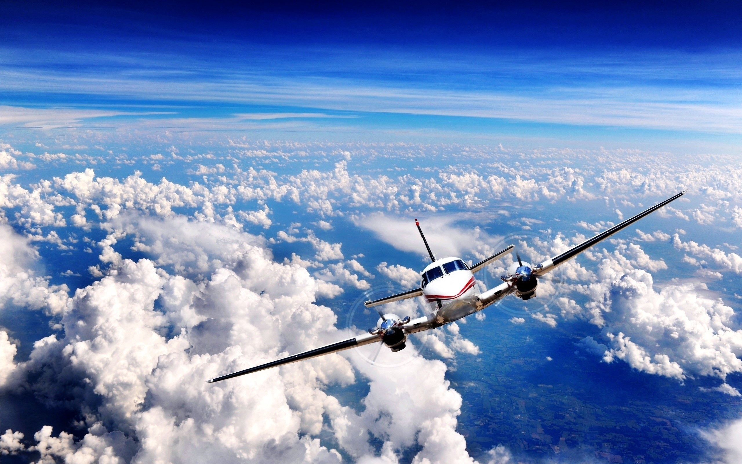 Airplane flying above clouds in the sky HD Wallpaper