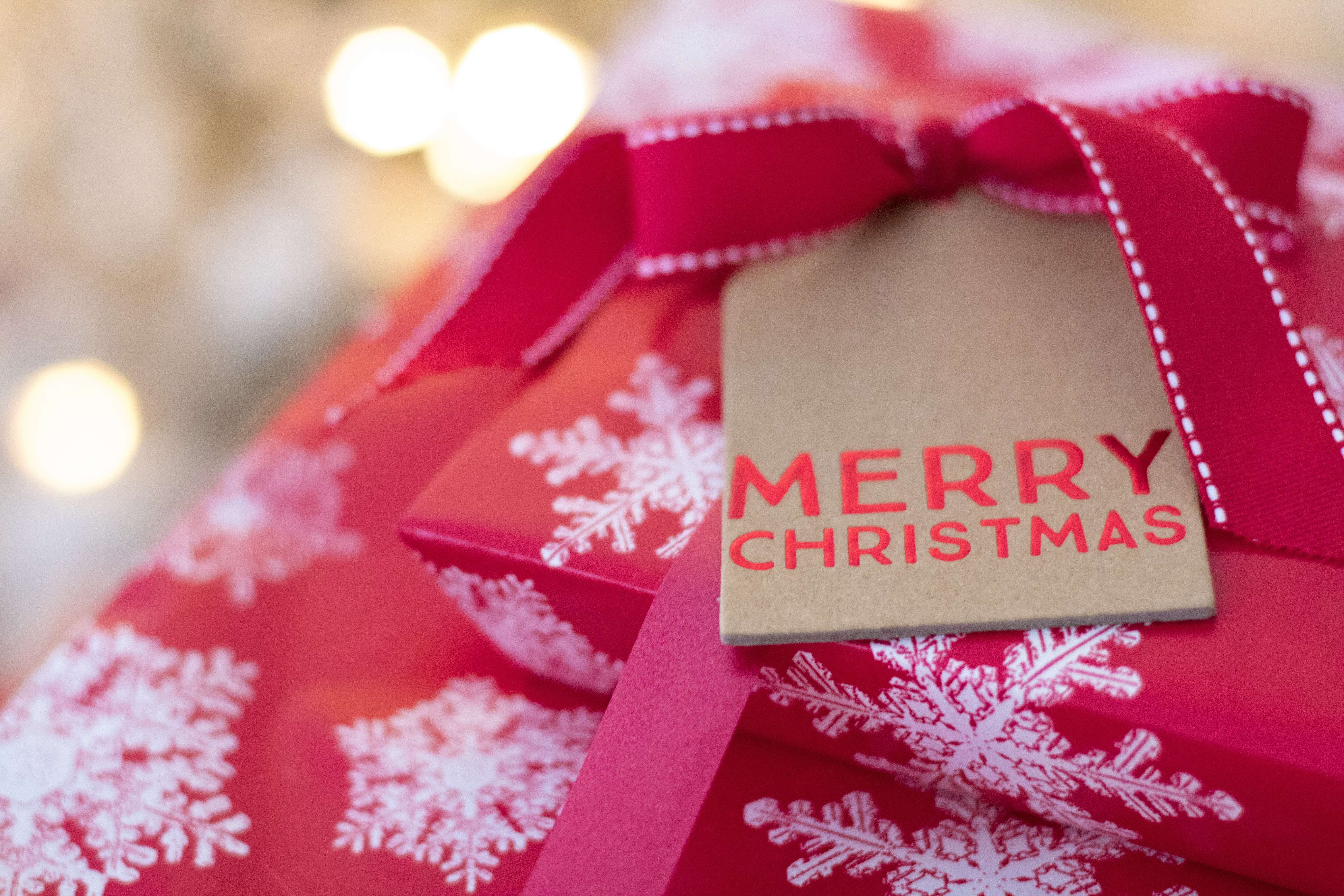 Merry Christmas gift with red ribbon and snowflakes HD Wallpaper