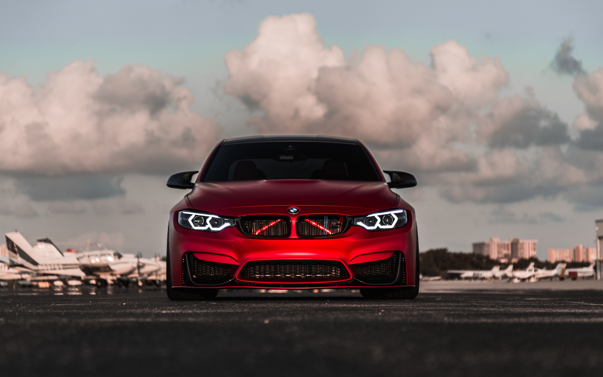 Red BMW M4 parked at an airfield HD Wallpaper