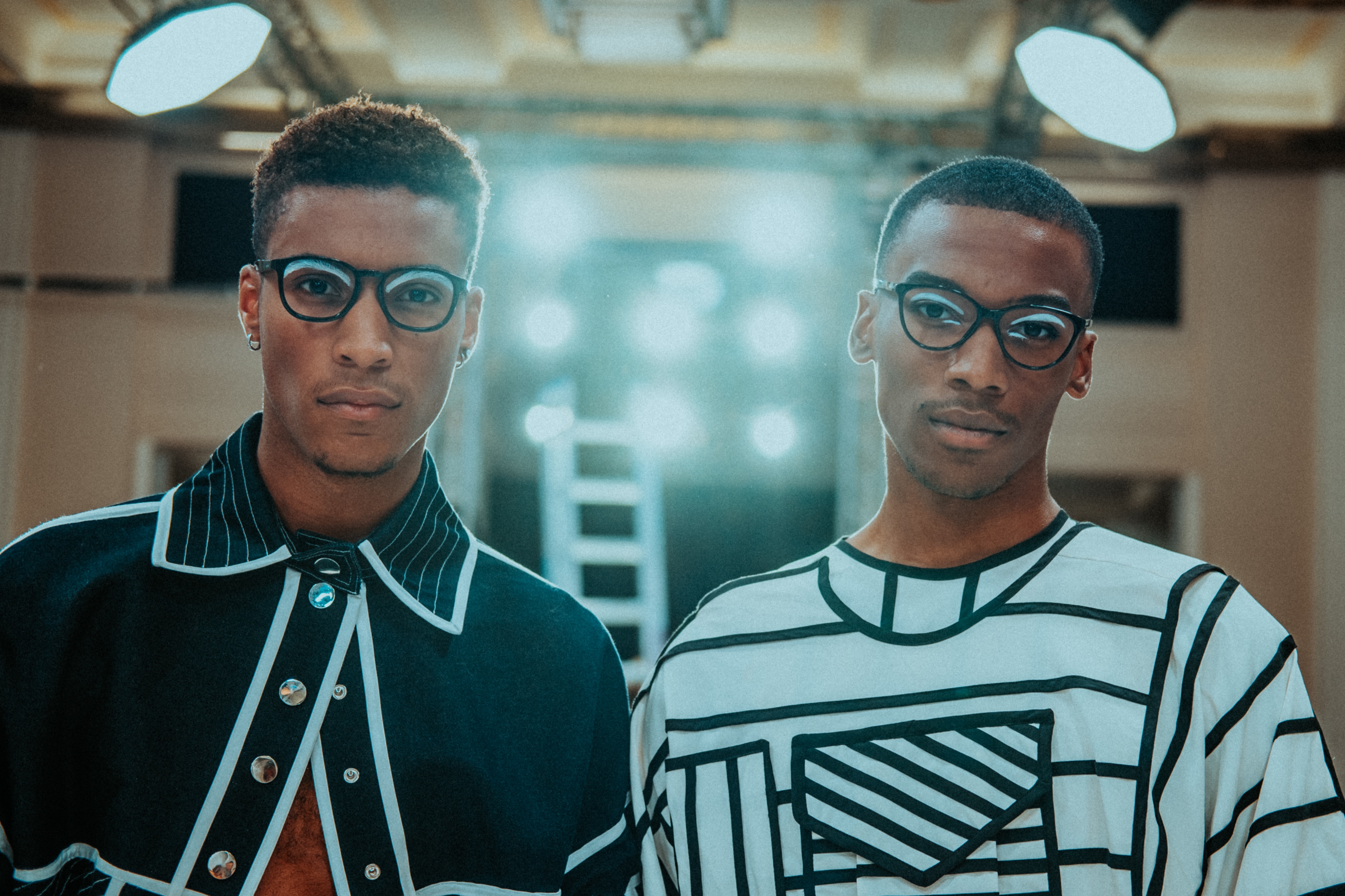 Two African American men wearing glasses and fashionable clothing HD Wallpaper