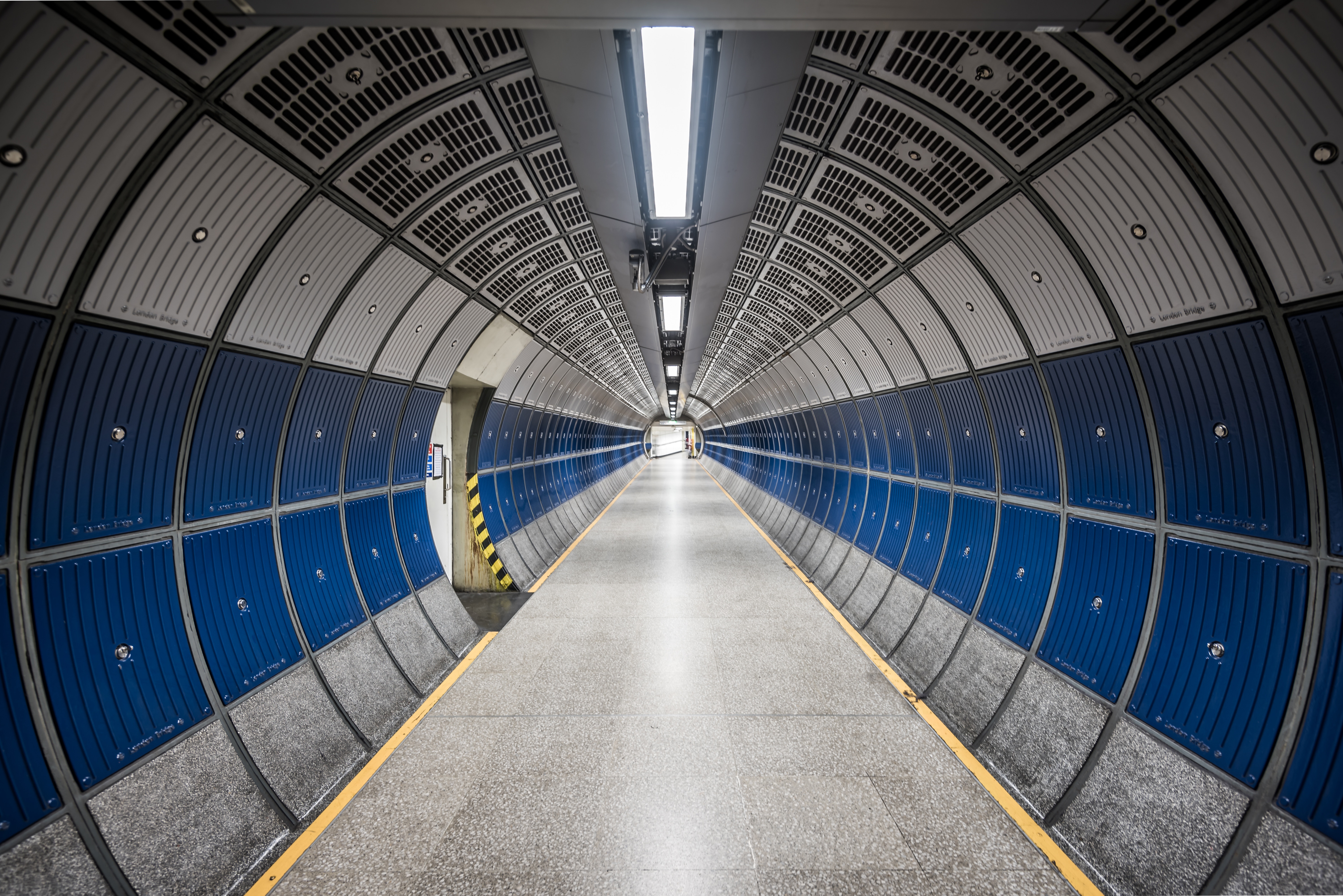 Empty geometric tunnel with blue and gray panels HD Wallpaper