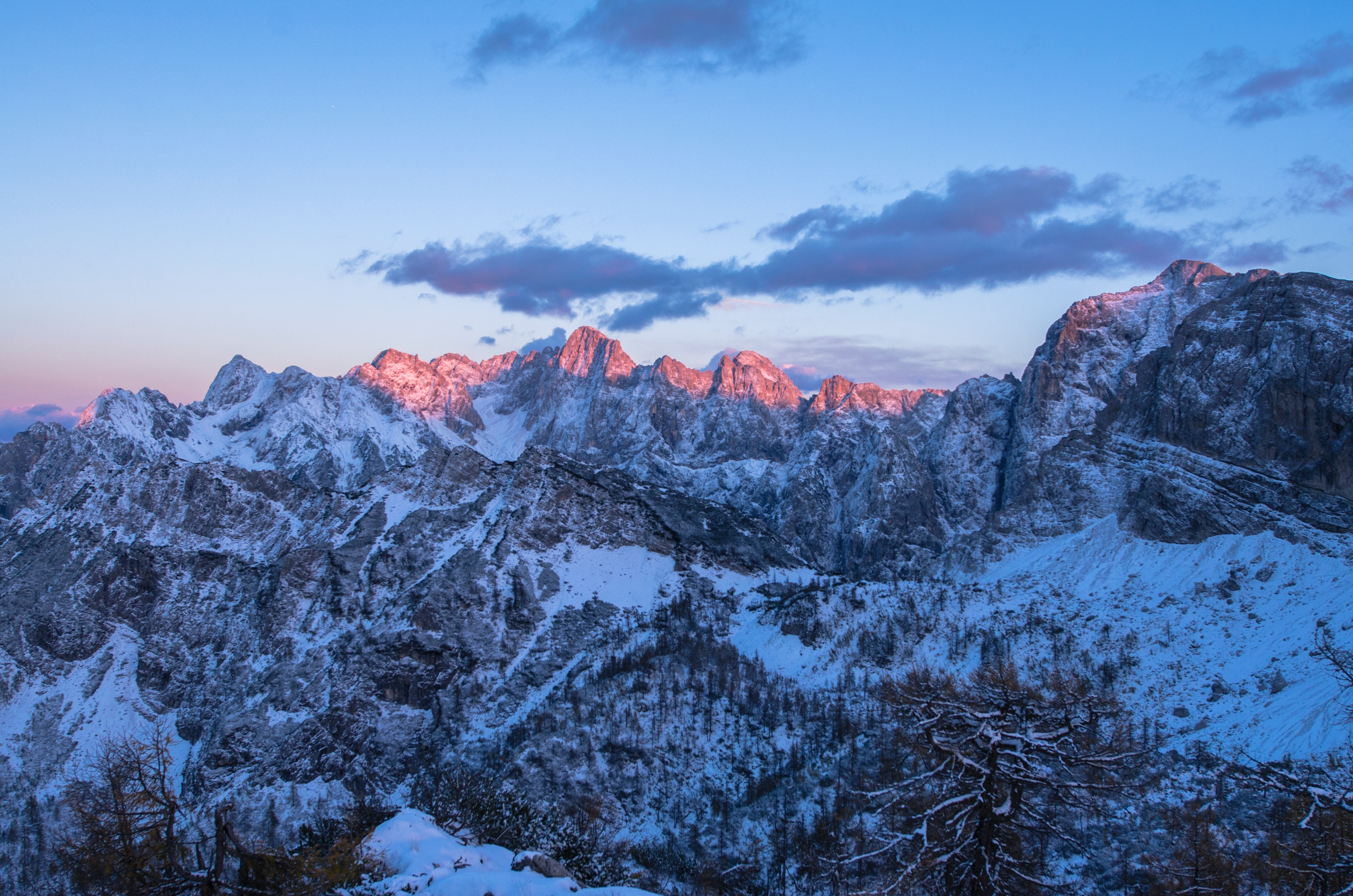 Snowy mountain range at sunrise with pink clouds HD Wallpaper