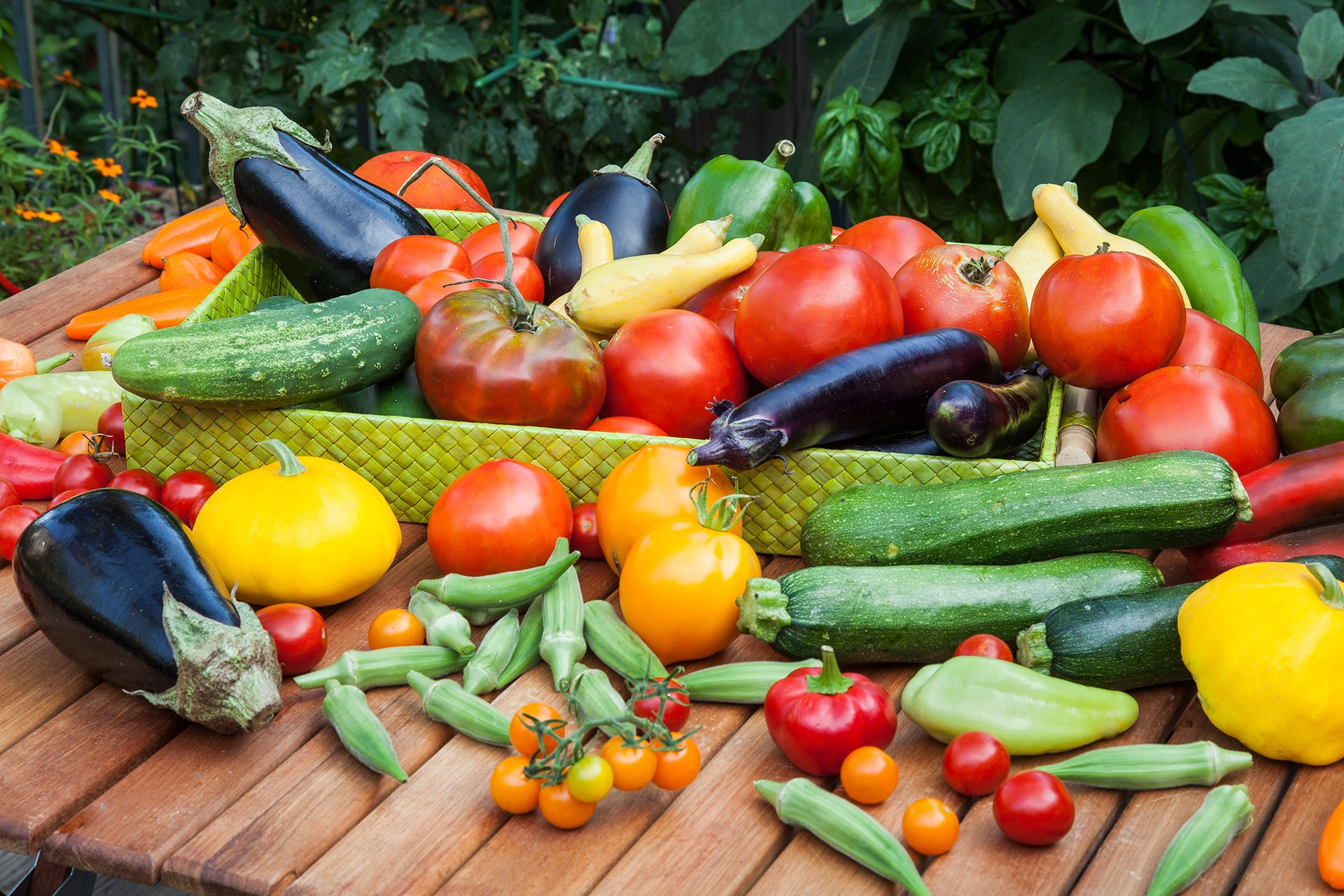 A bountiful harvest of fresh vegetables on a wooden table HD Wallpaper