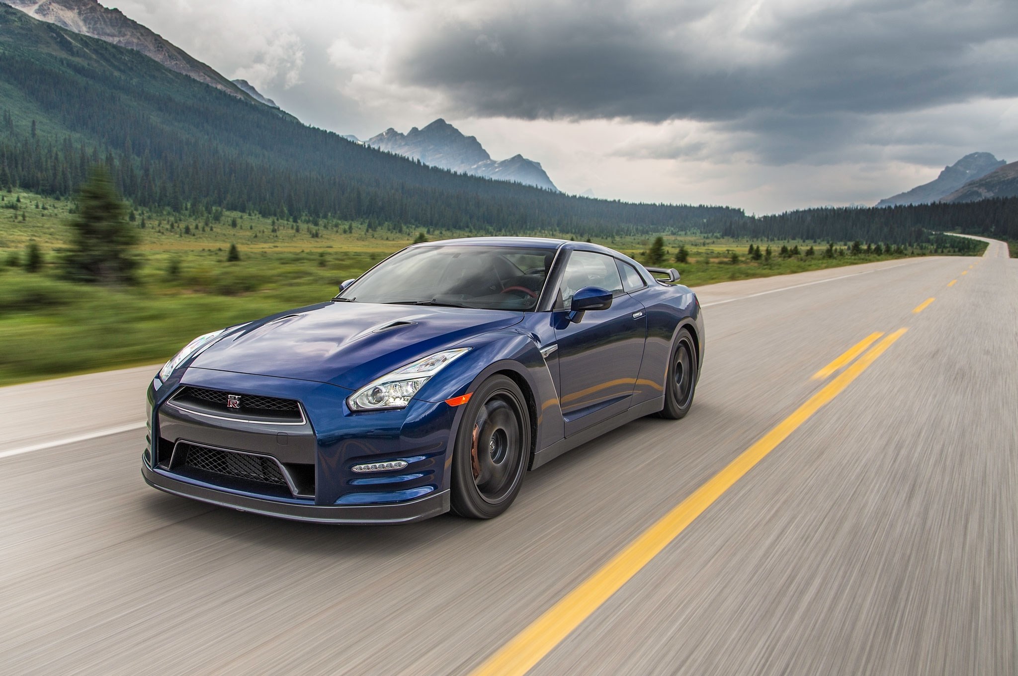 Blue Nissan GT-R driving on a mountain road HD Wallpaper