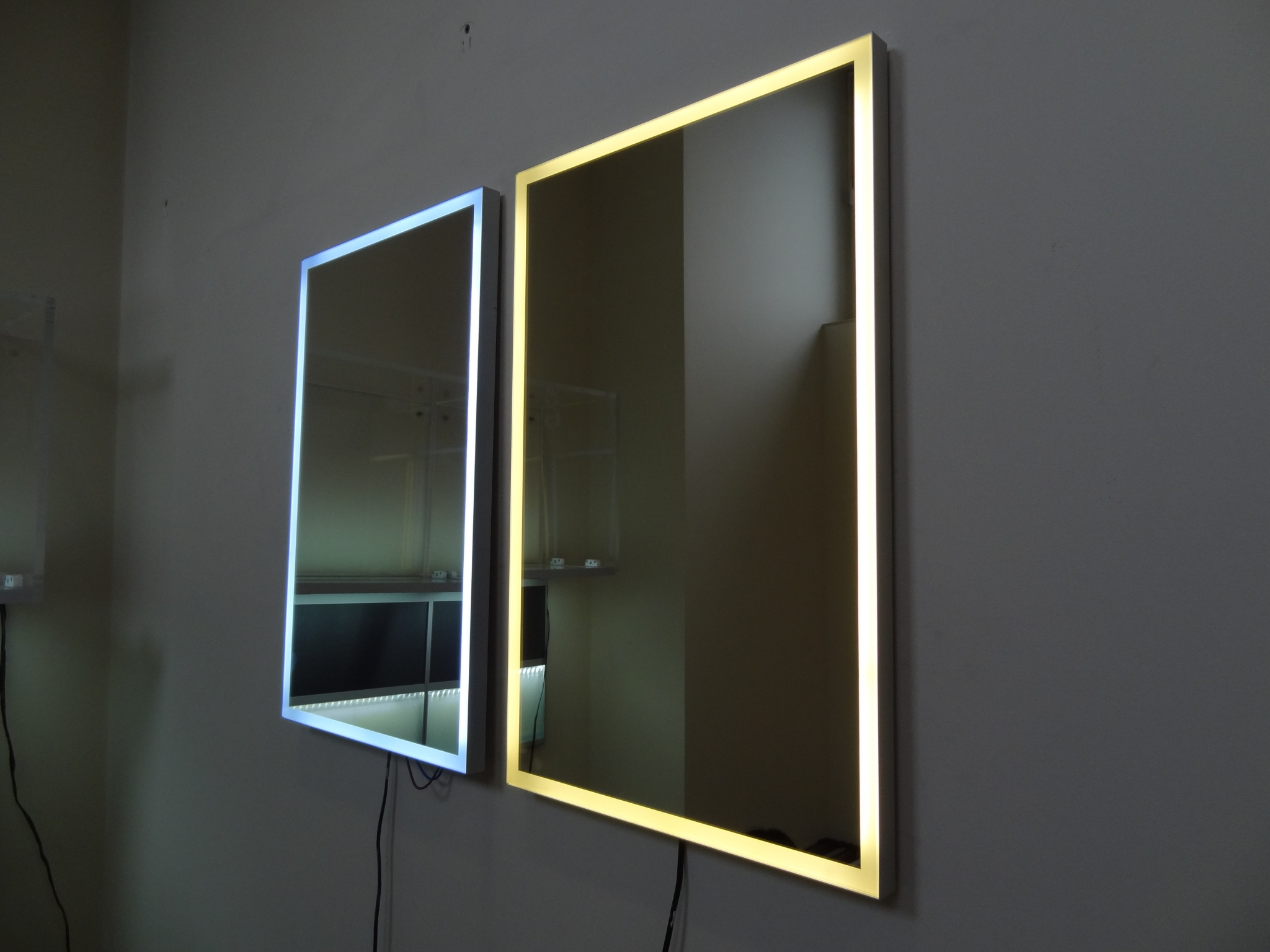 Two illuminated mirrors on a wall HD Wallpaper