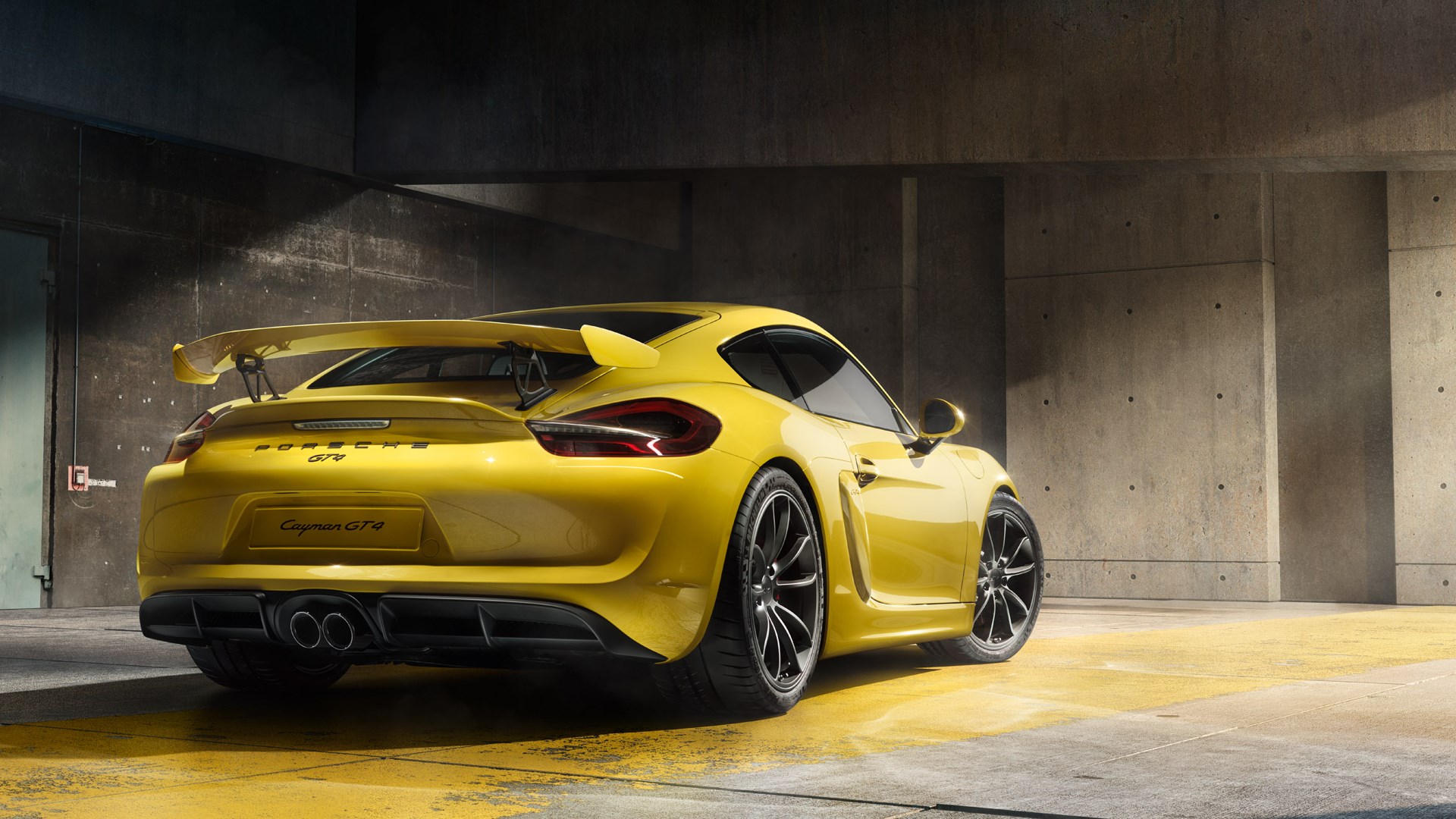 Yellow Porsche Cayman GT4 in a concrete garage HD Wallpaper