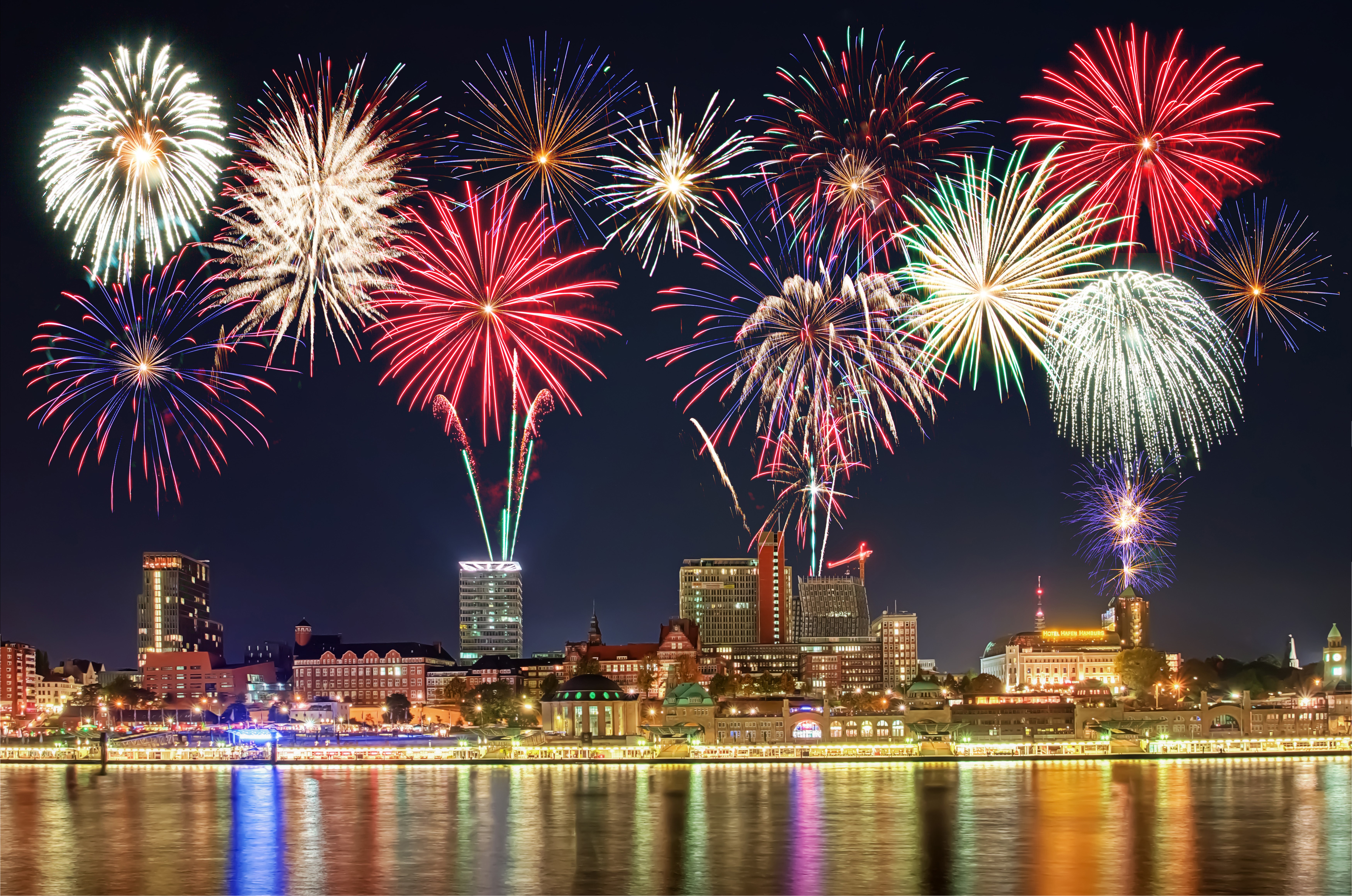 Colorful Fireworks Over City Waterfront at Night HD Wallpaper