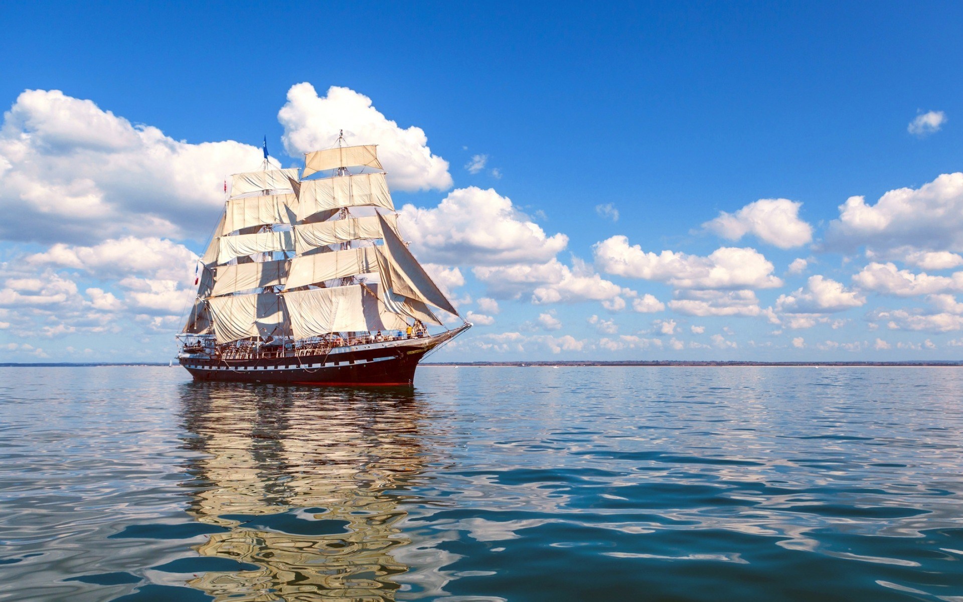 Sailing ship on the water under a blue sky HD Wallpaper