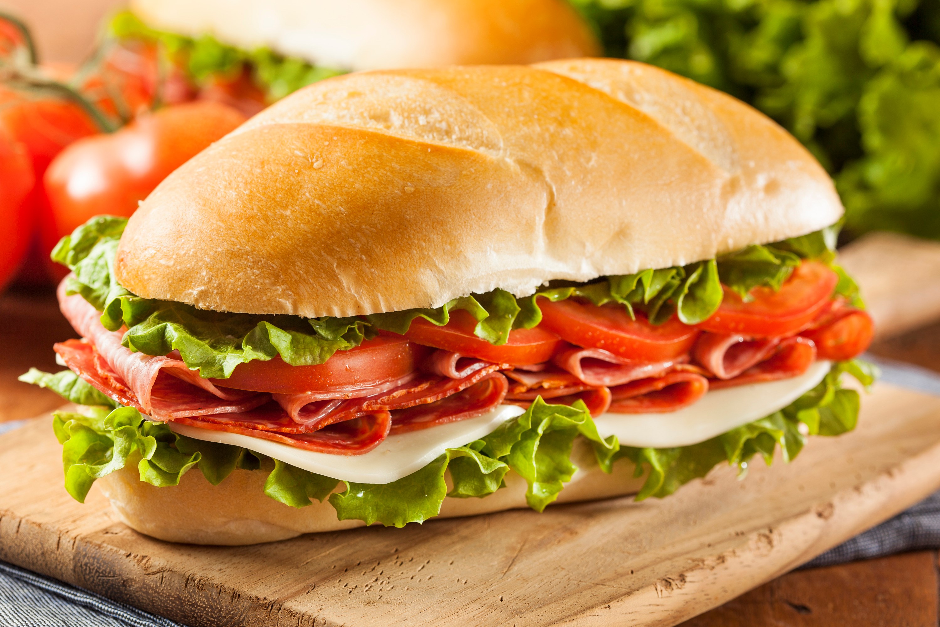 Italian sub sandwich with salami, cheese, lettuce, and tomato HD Wallpaper