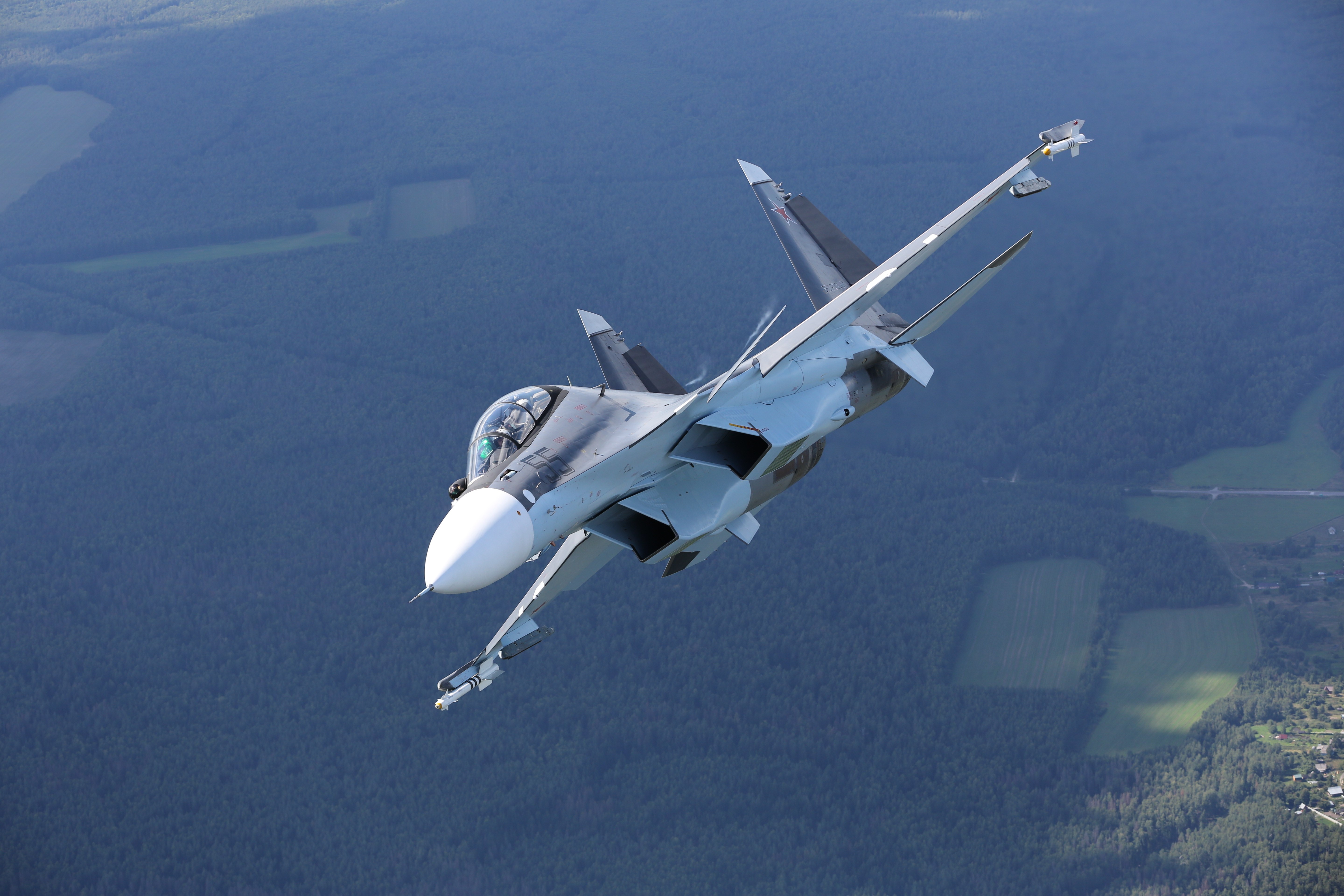 Sukhoi Su-30 fighter jet in flight over forest HD Wallpaper
