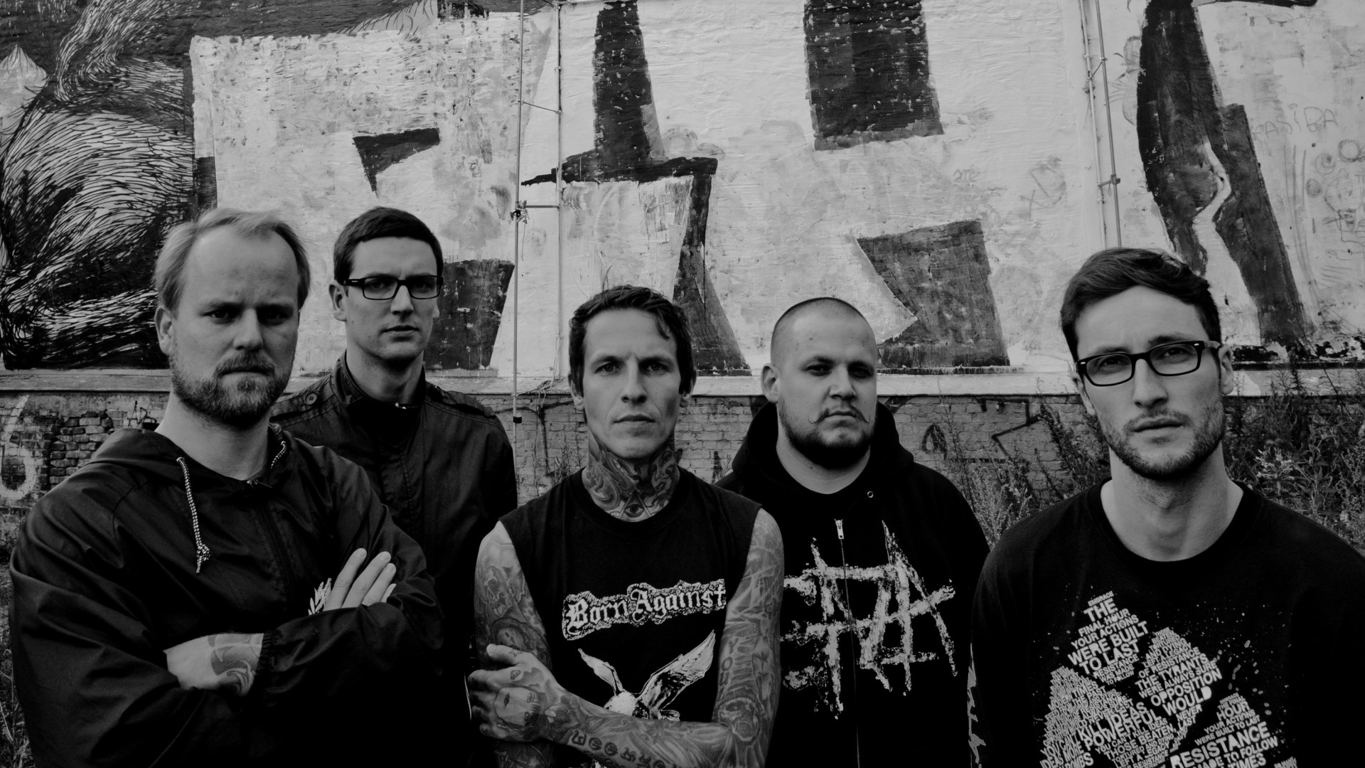 Band members posing in front of graffiti wall HD Wallpaper